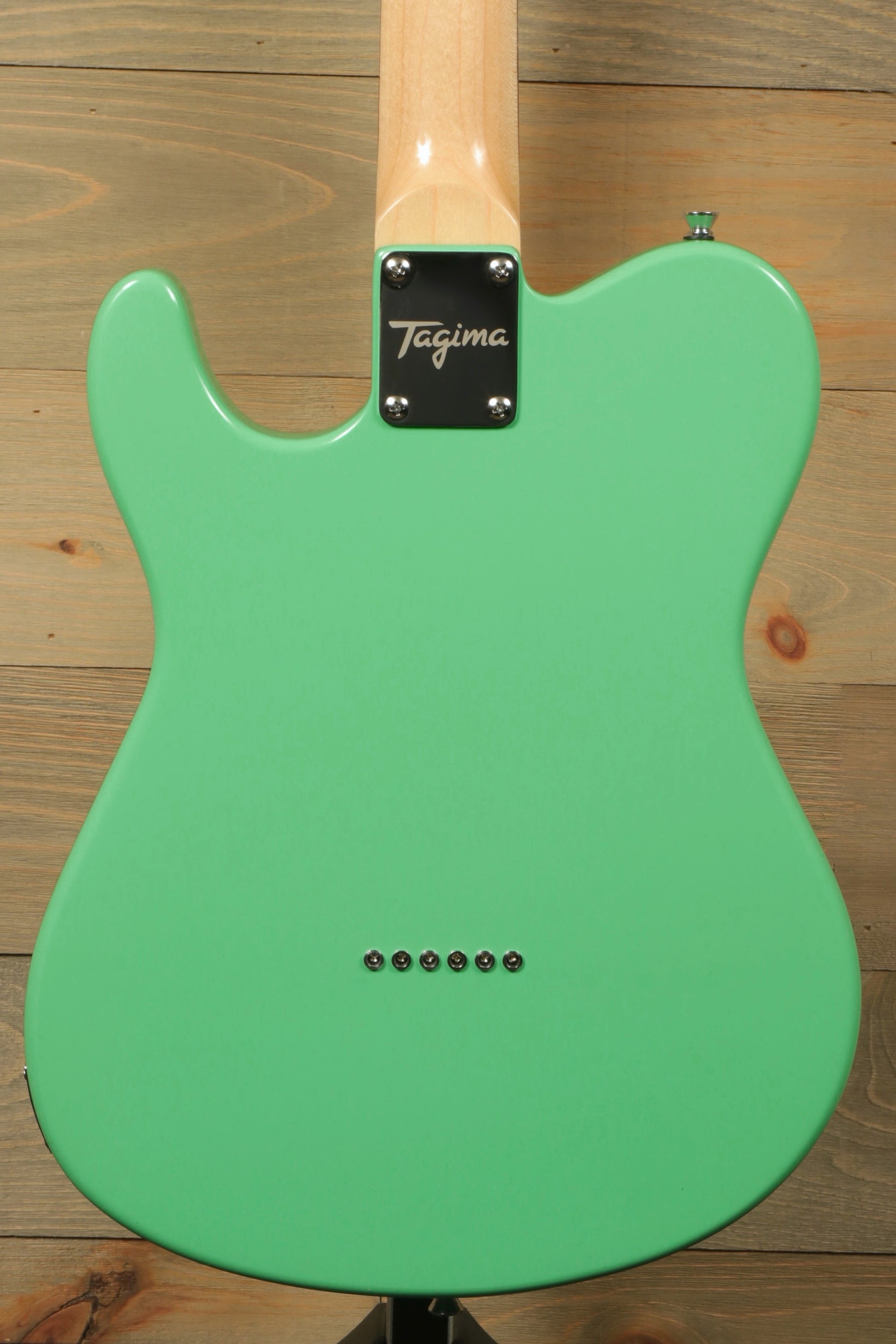 Tagima electric guitar guitars in mint green, back view showcasing sleek finish and hardware