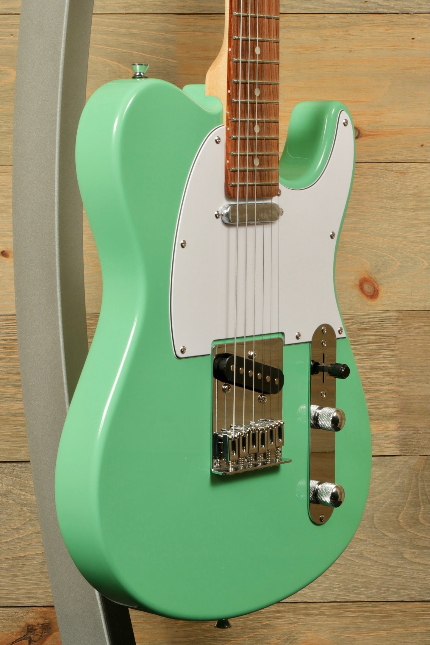 Tagima electric guitar guitars in mint green finish, side view with a solid body.