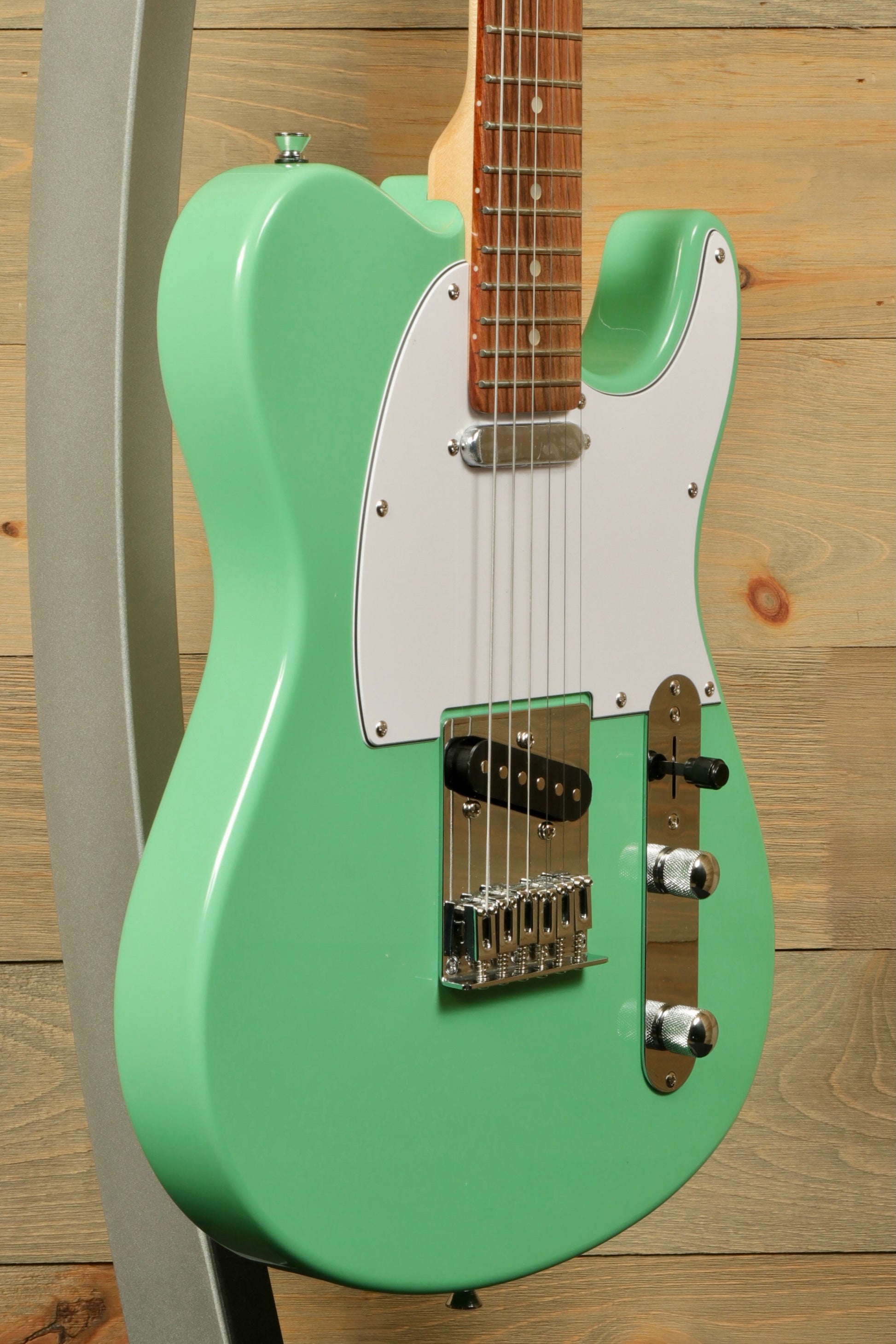 Tagima electric guitar guitars in mint green finish, side view with a solid body.