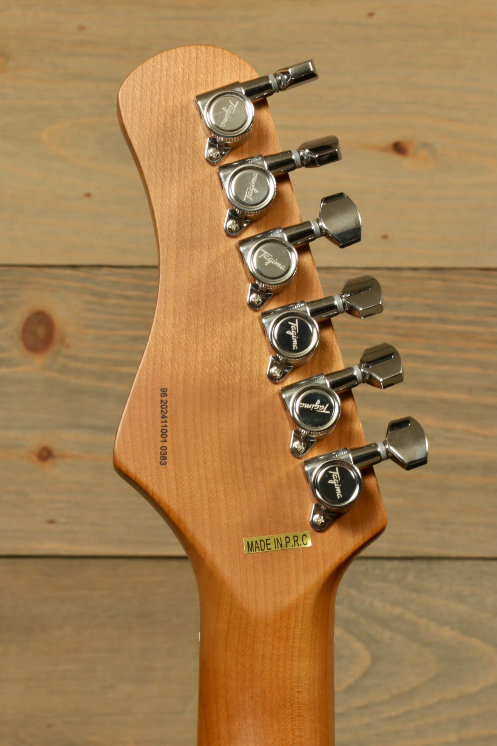 Tagima electric guitar guitars headstock view with six tuning pegs and natural wood finish