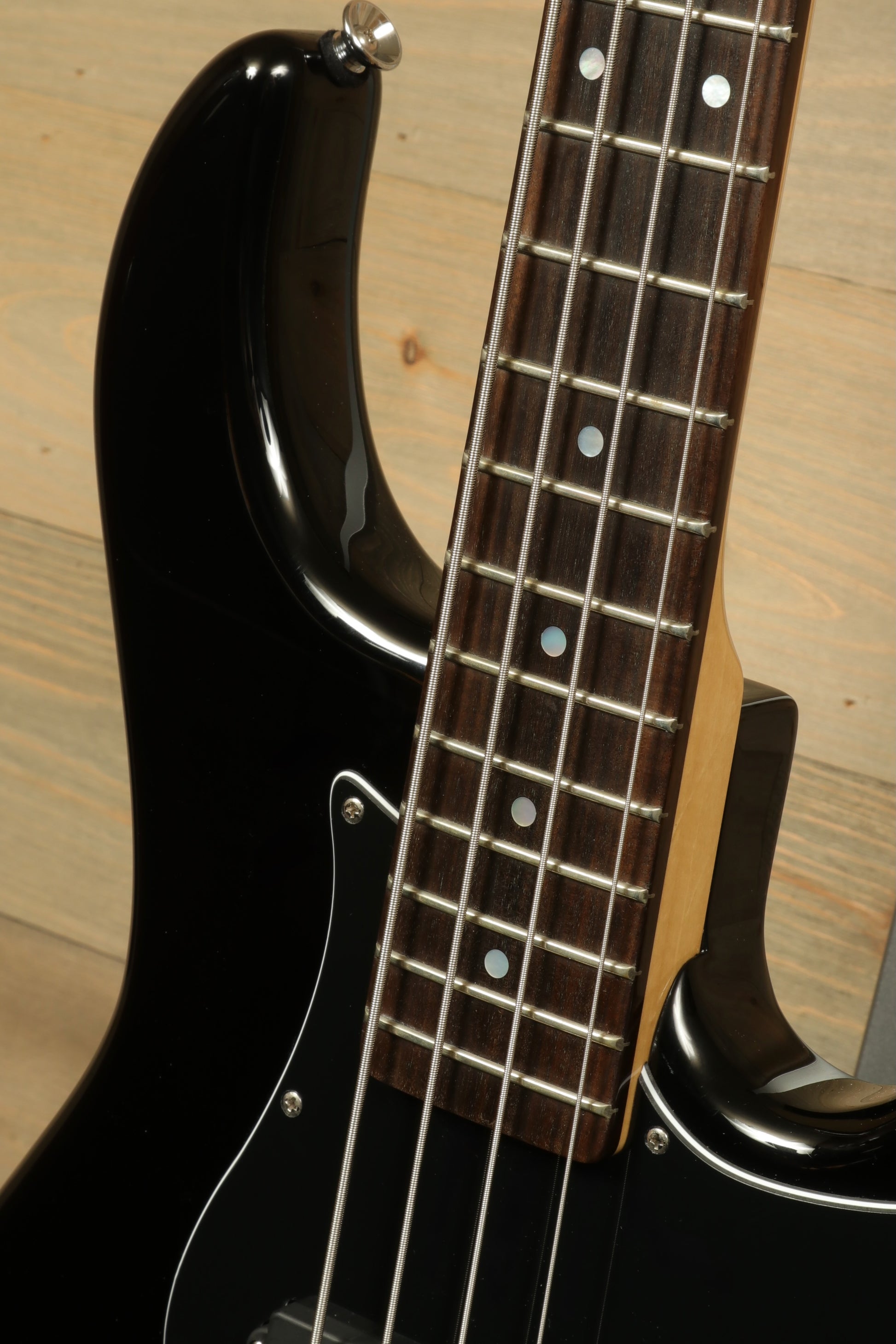 Tagima Fusion-4 H2 bass guitar with sleek black body and polished wooden neck for smooth performance