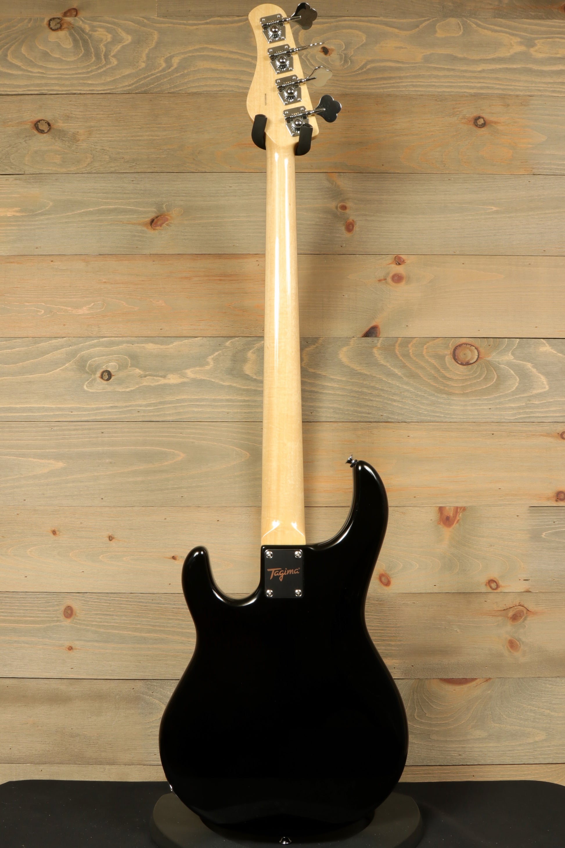Back view of Tagima Fusion-4 H2 bass guitar showcasing its sleek black finish and smooth neck