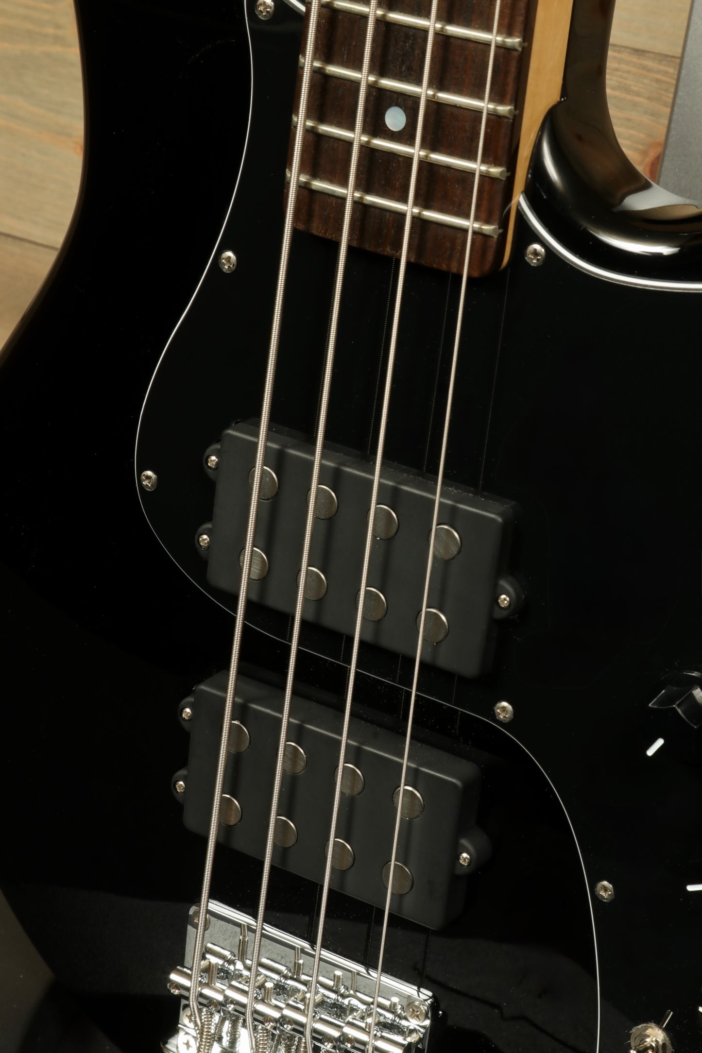 Close-up of Tagima Fusion-4 H2 bass guitar showcasing pickups and strings for musicians