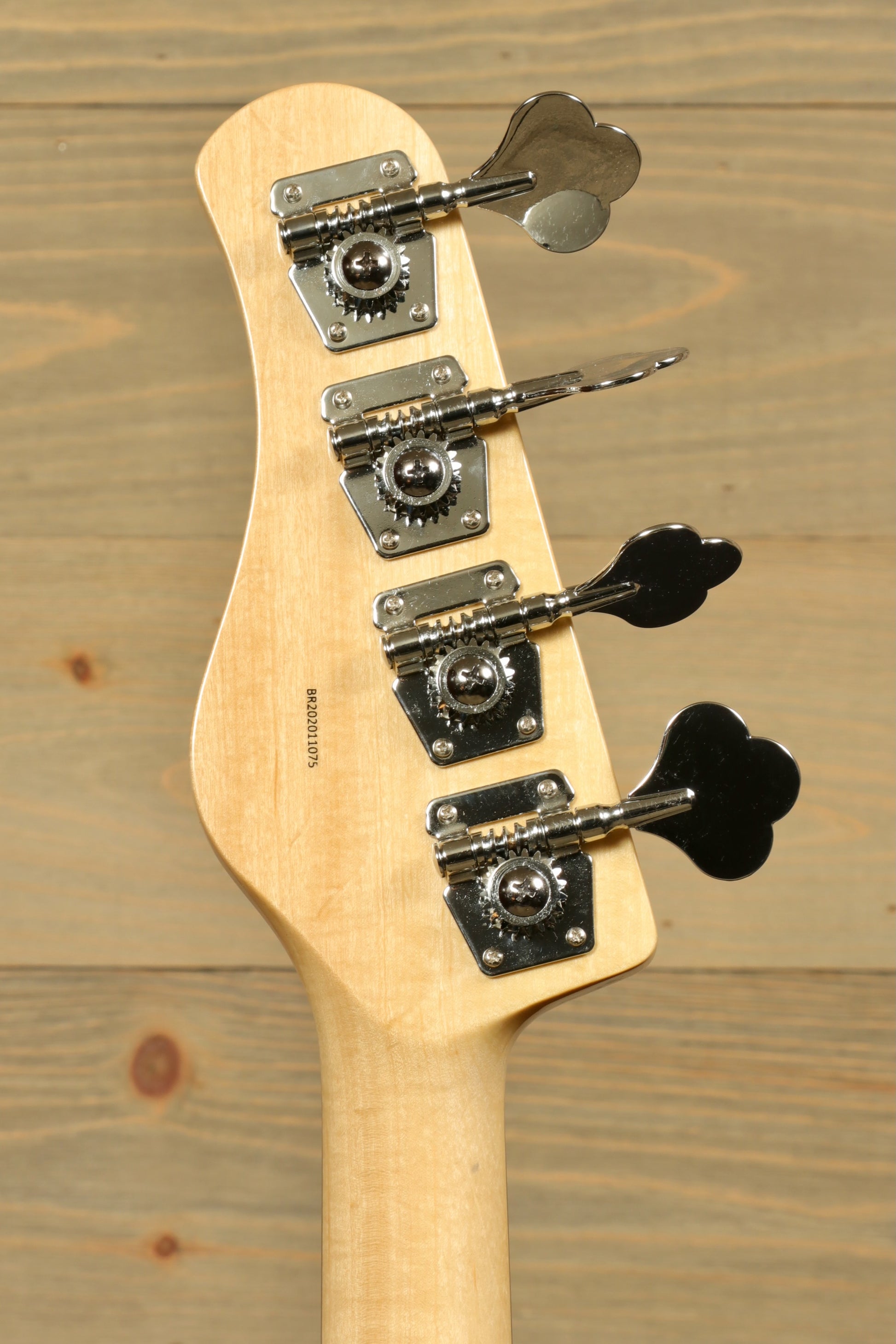 Back view of Tagima Fusion-4 H2 bass guitar headstock with tuning pegs and smooth finish