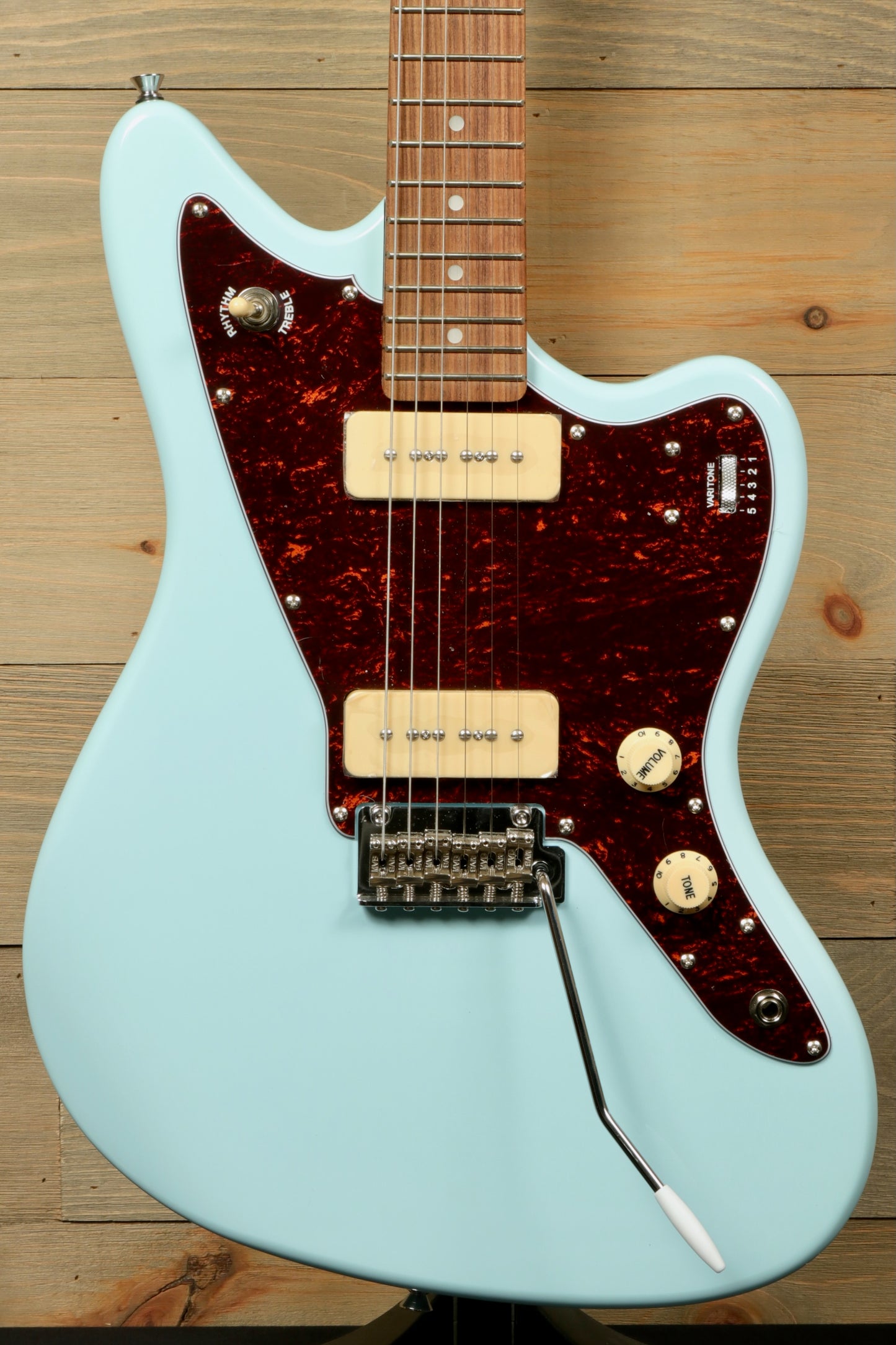 Tagima Jazz Electric Guitar in light blue with a unique pickguard, front view displaying controls