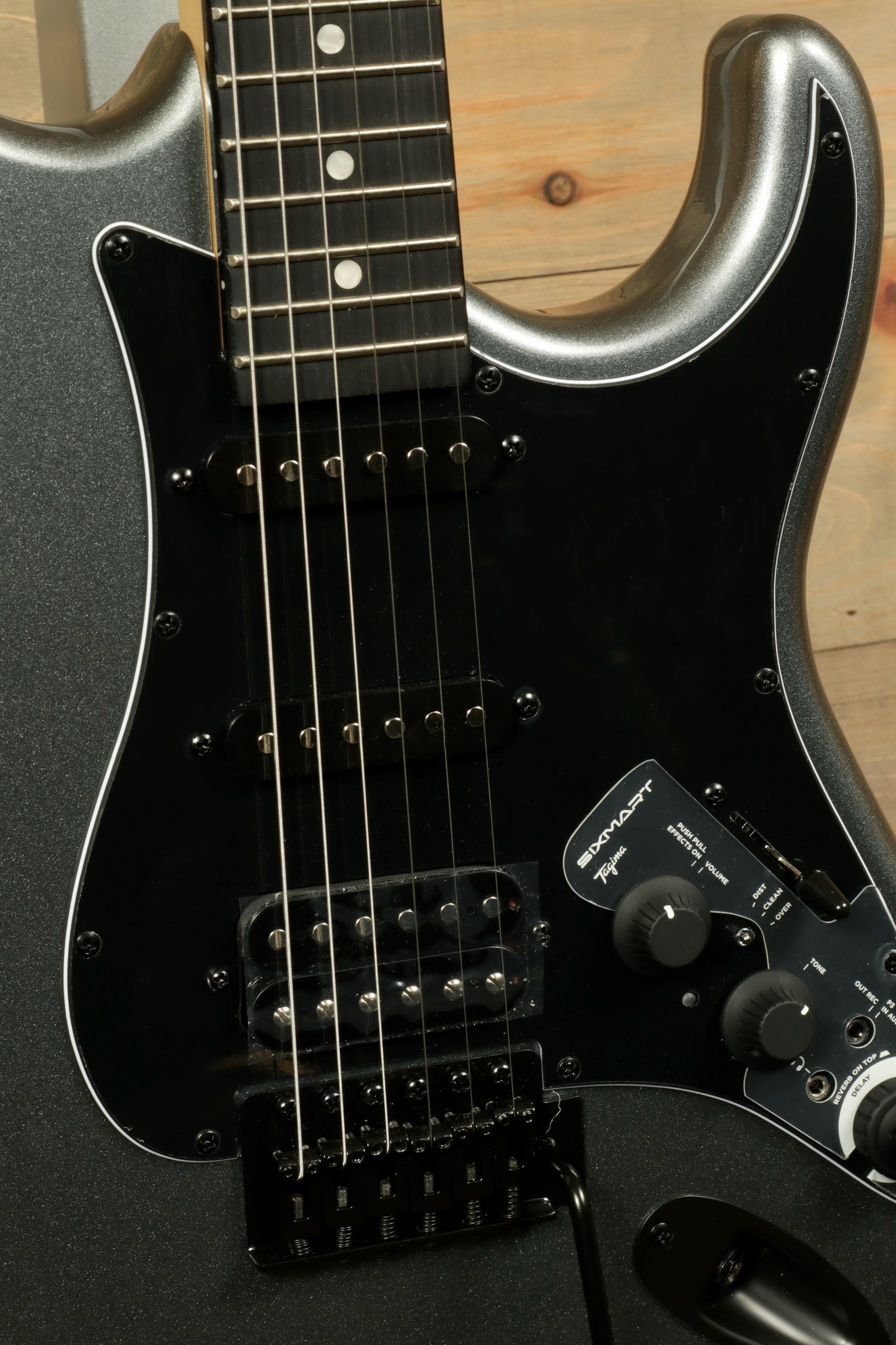 Close-up view of Tagima Sixmart electric guitar featuring a sleek design and control knobs