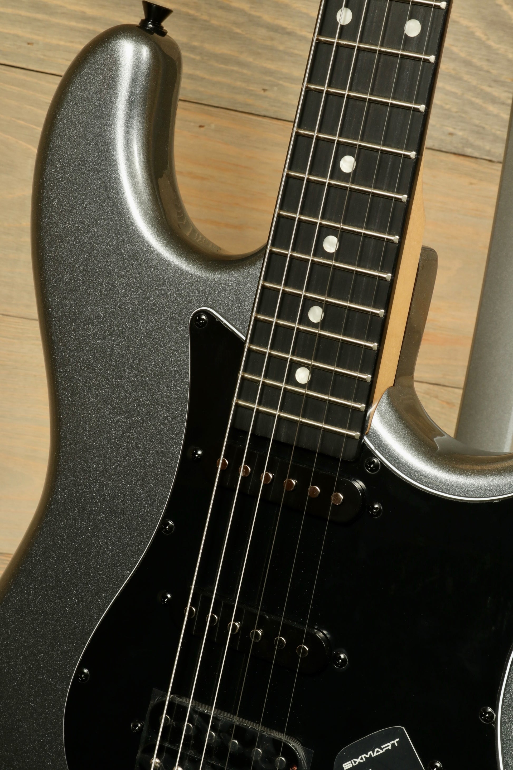 Close-up of Tagima Sixmart electric guitar with sleek black finish and smooth fretboard