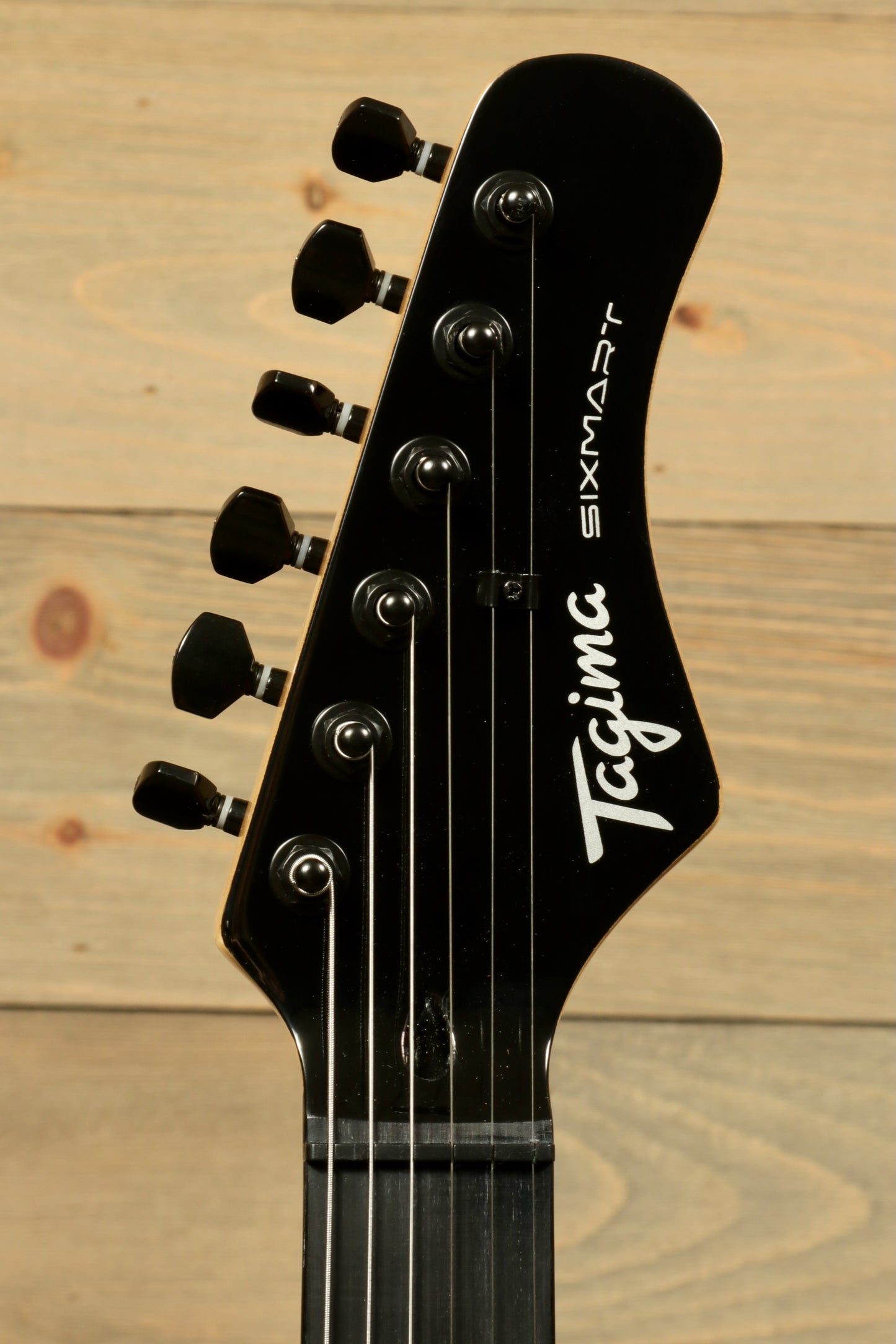 Tagima Sixmart electric guitar headstock featuring six tuning pegs and sleek design
