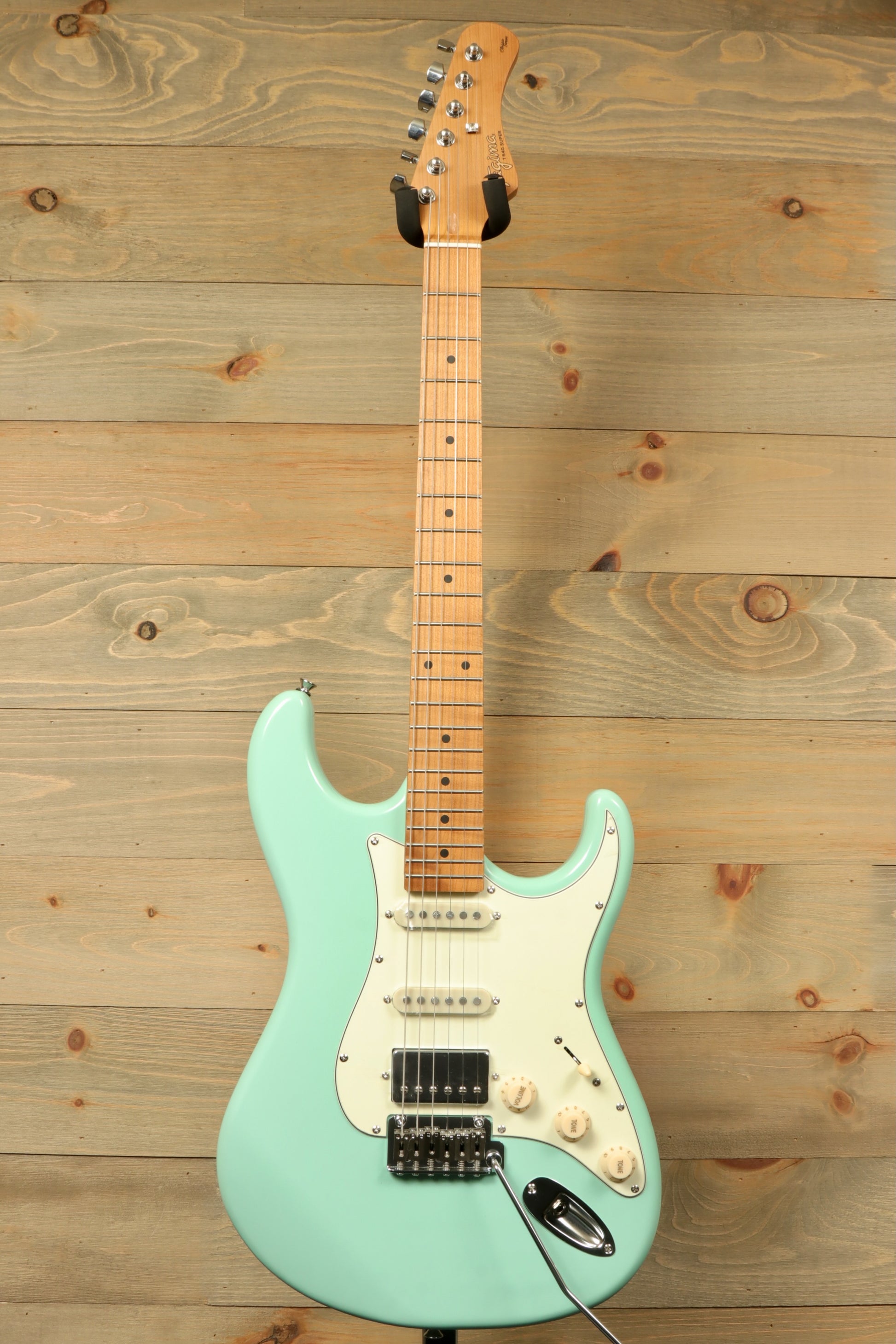 Tagima T 640 SUPER electric guitar in seafoam green, front view showcasing body and neck