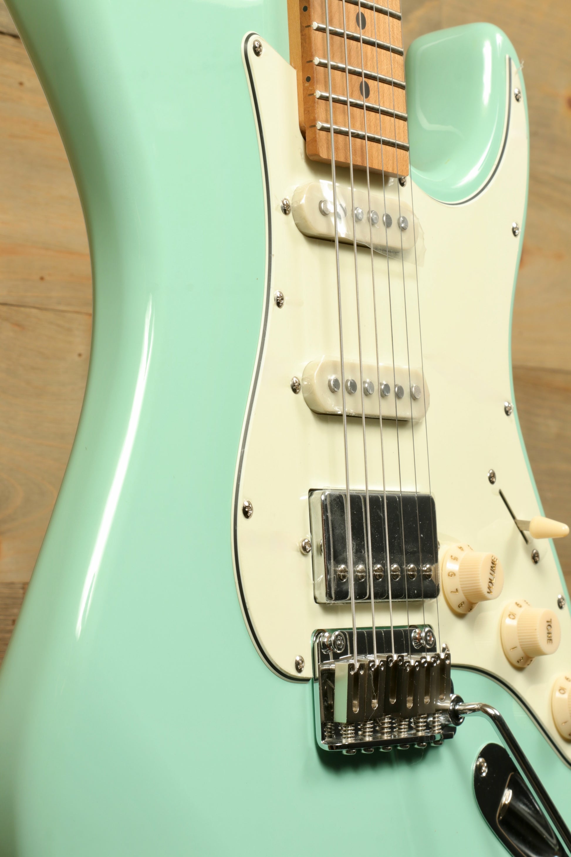 Tagima T 640 SUPER mint green electric guitar, close-up view showcasing the body and pickups