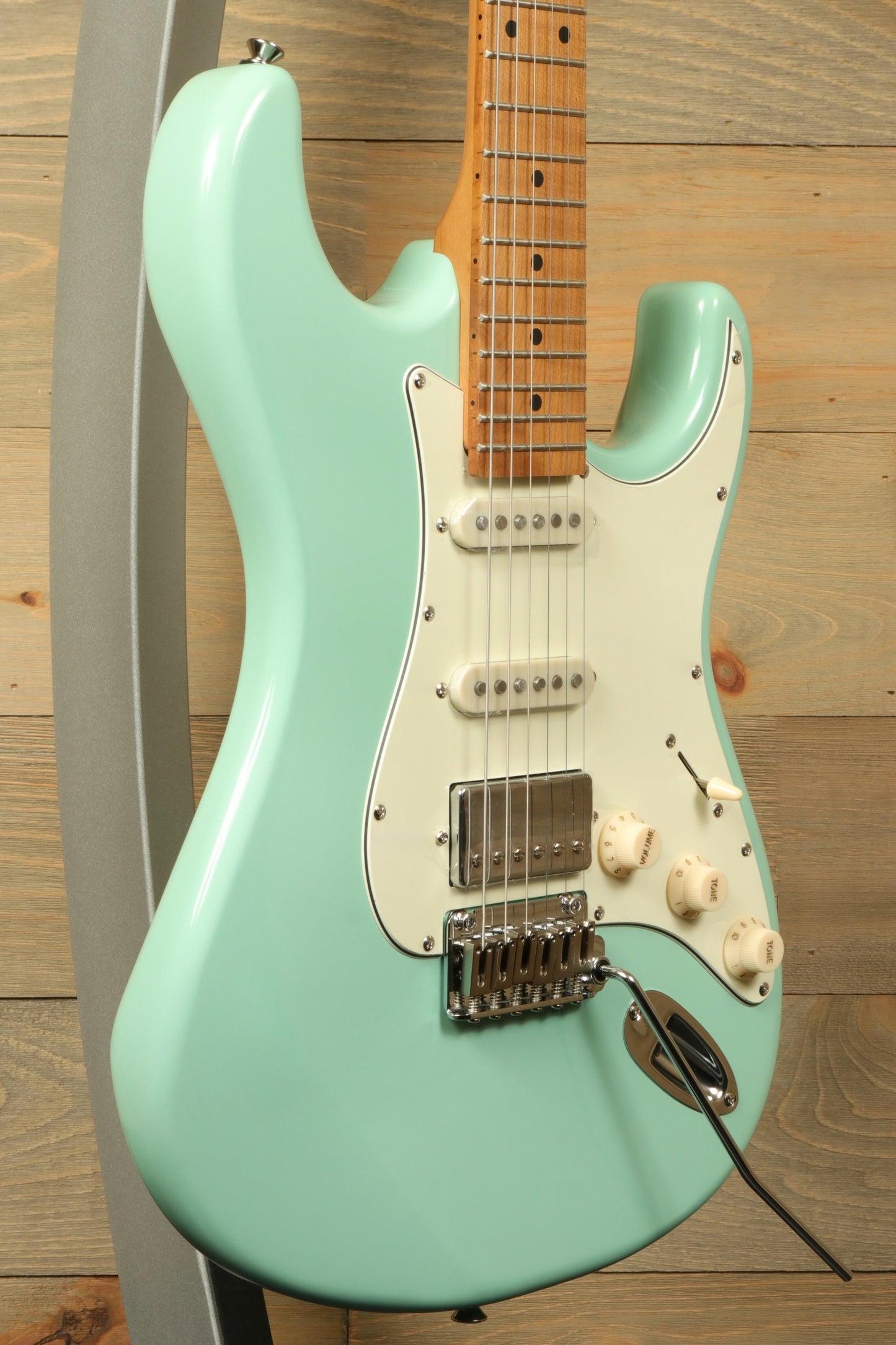 Tagima T 640 SUPER electric guitar in mint green, side view with maple neck and white pickguard