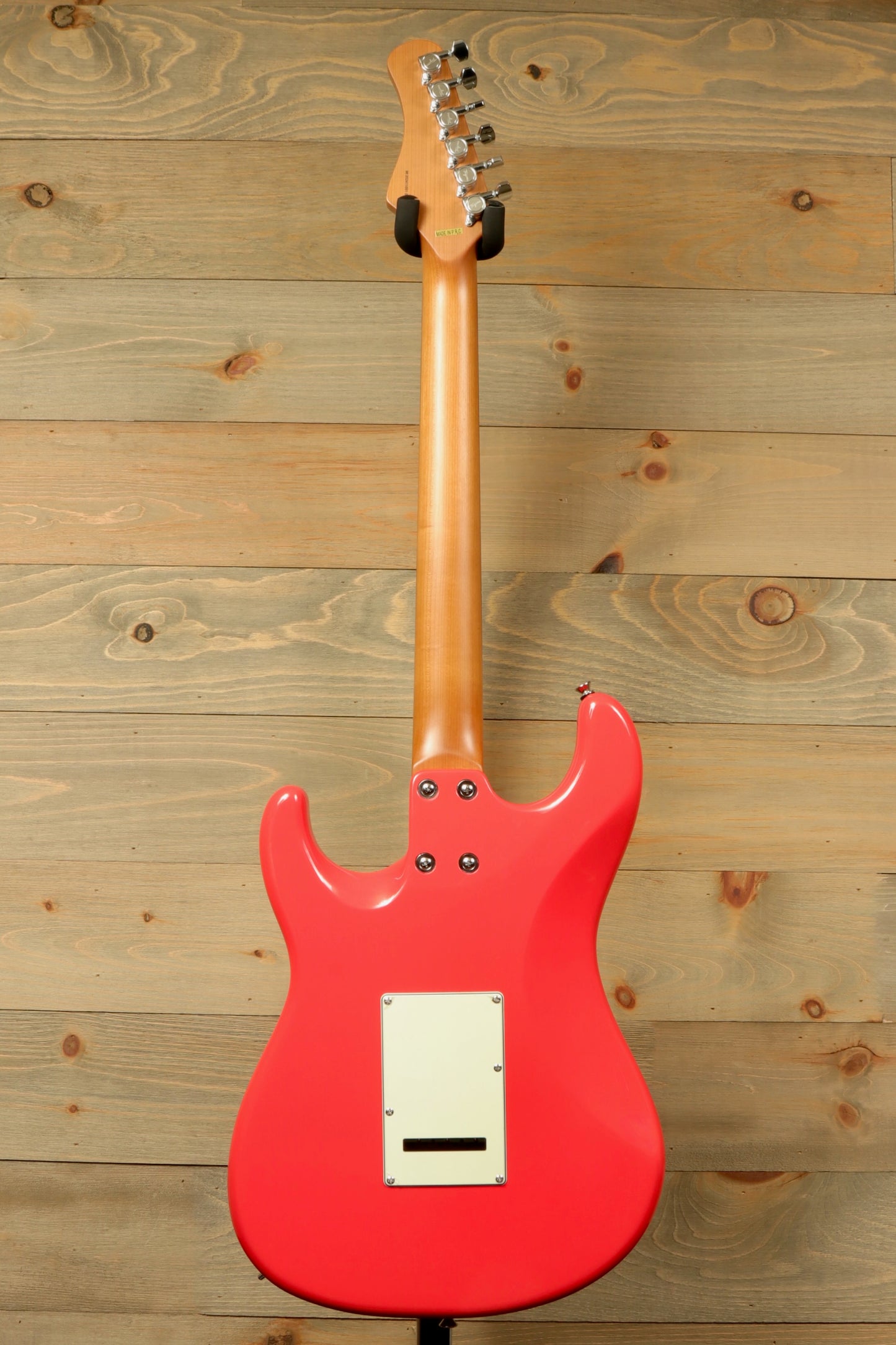 Tagima T 640 SUPER electric guitar in coral pink, rear view showcasing smooth finish