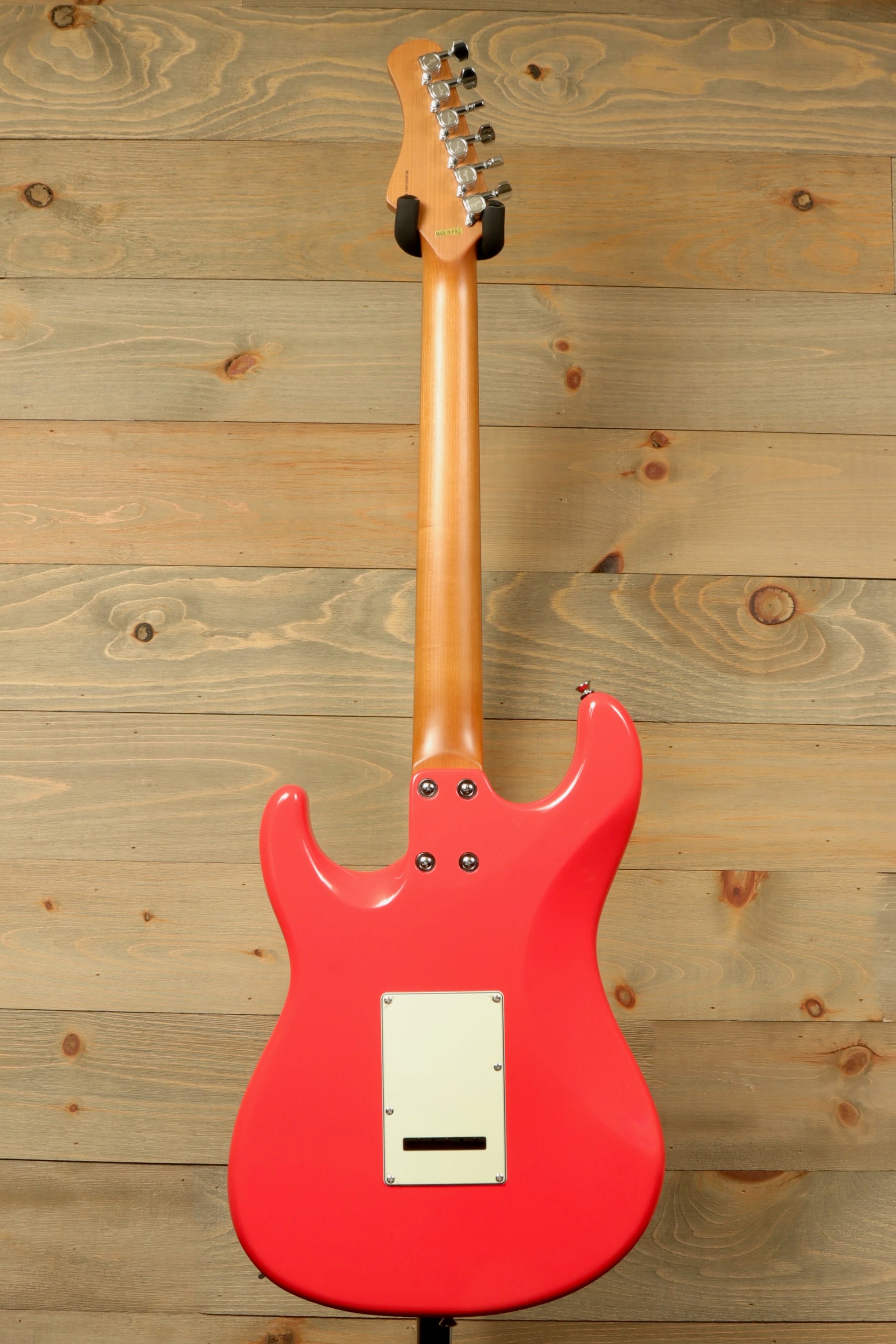 Tagima T 640 SUPER electric guitar in coral pink, rear view showcasing smooth finish