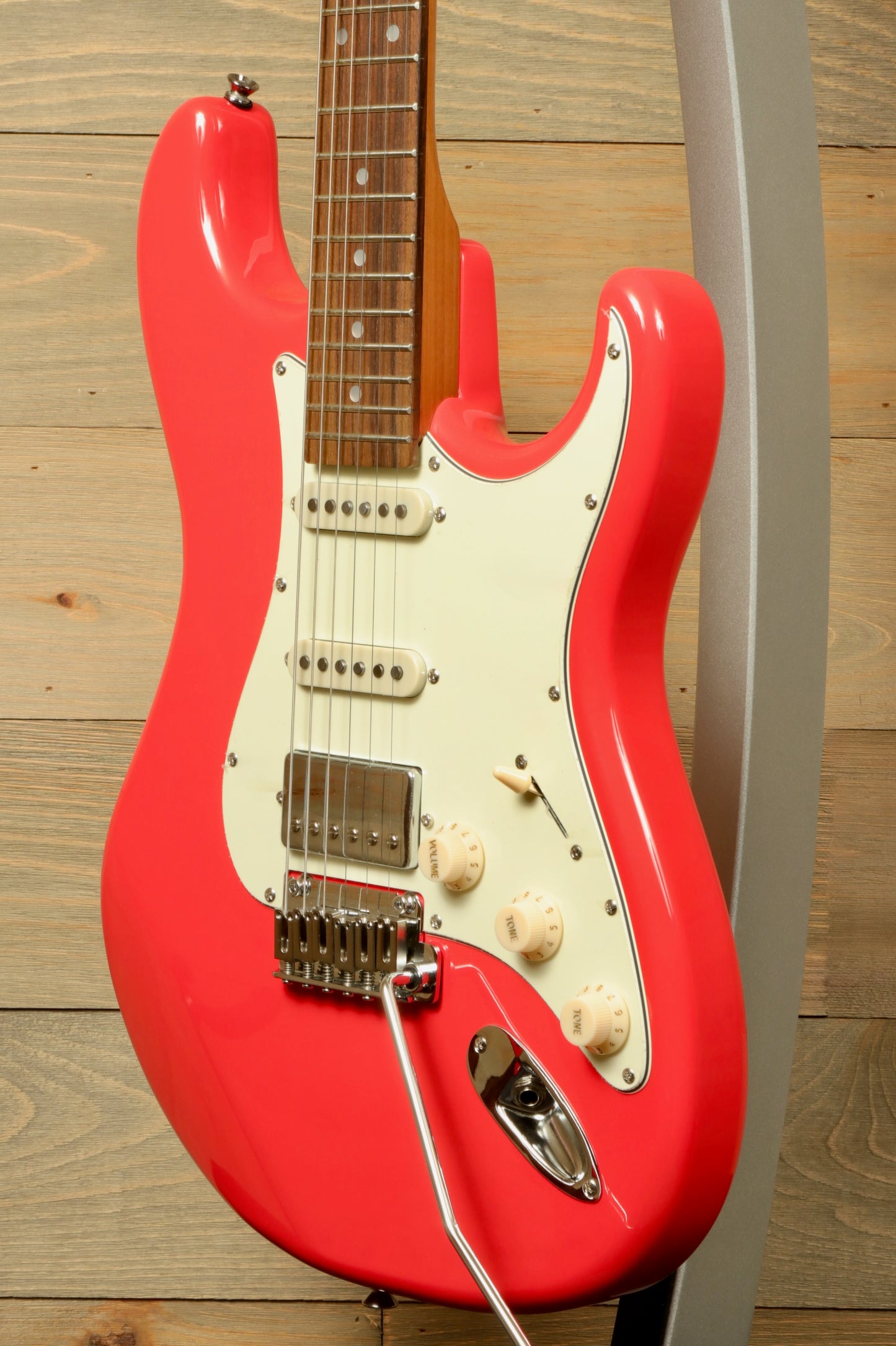 Tagima T 640 SUPER electric guitar in bright coral red with white pickguard, front view