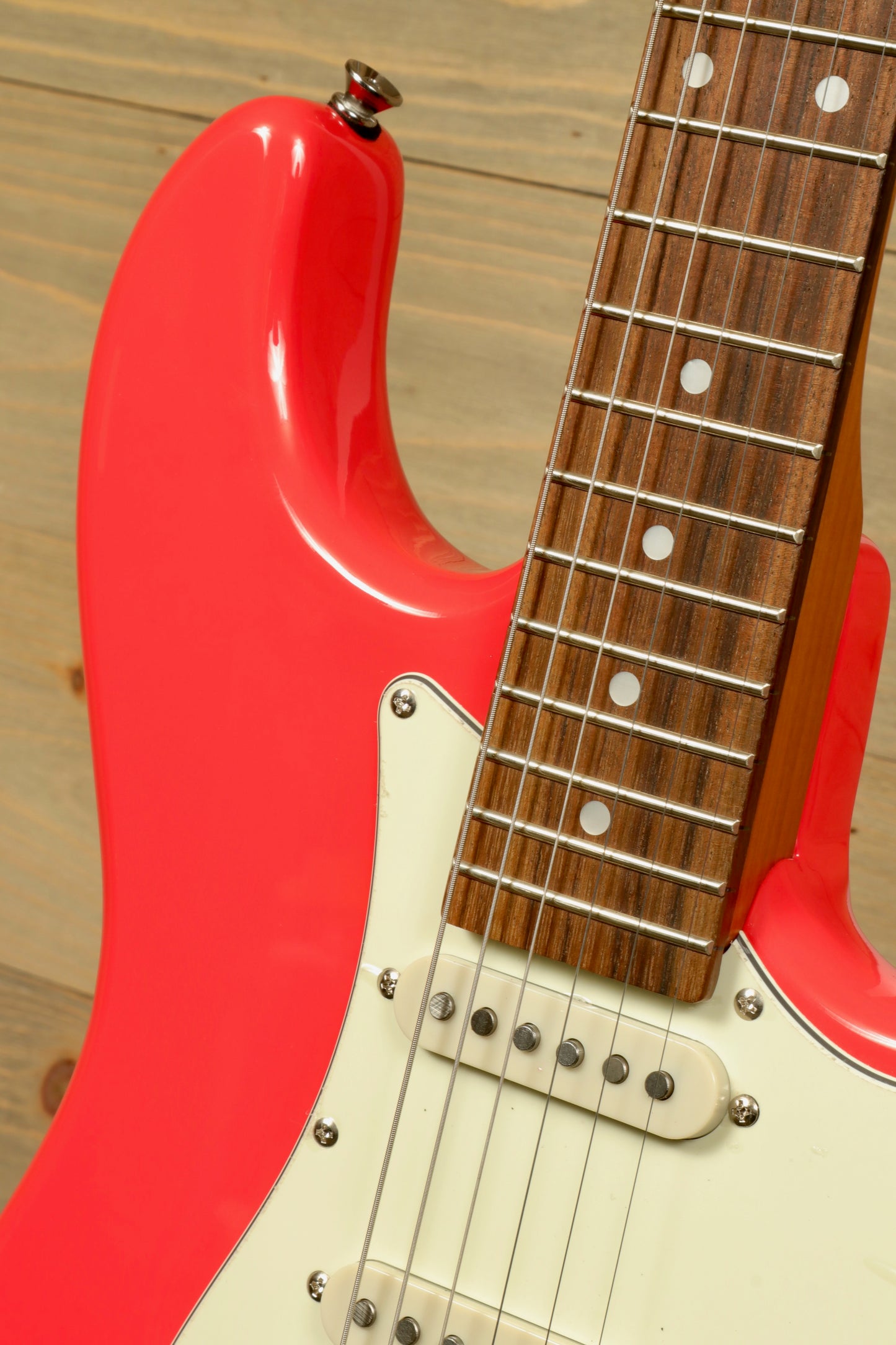 Tagima T 640 SUPER electric guitar in bright pink, showcasing the body and fretboard detail