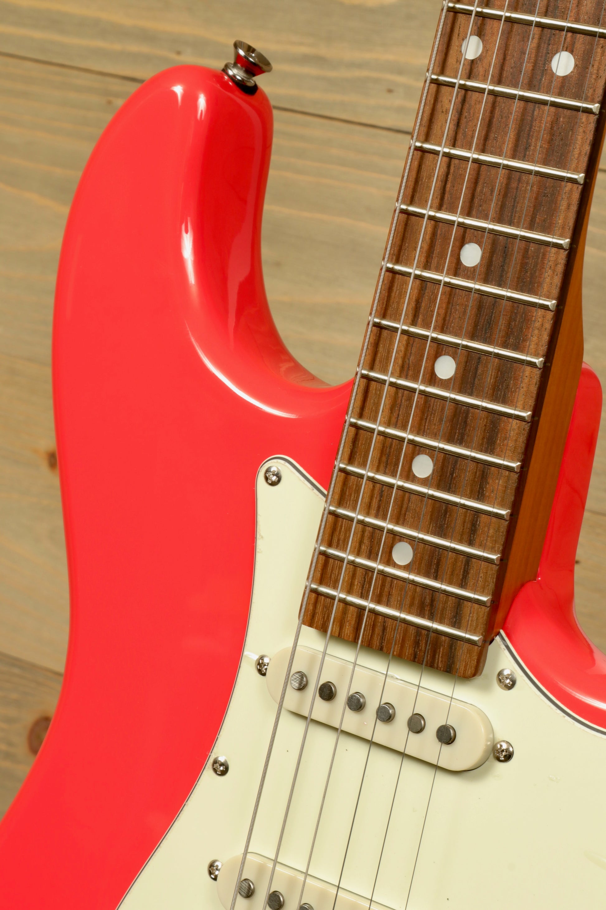 Tagima T 640 SUPER electric guitar in bright pink, showcasing the body and fretboard detail