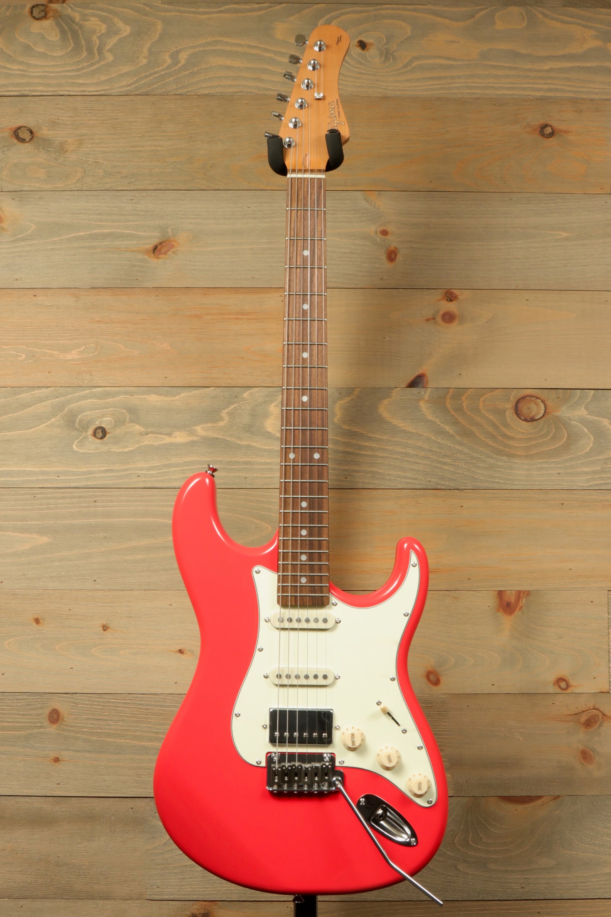 Tagima T 640 SUPER electric guitar in bright pink, front view with rosewood fretboard