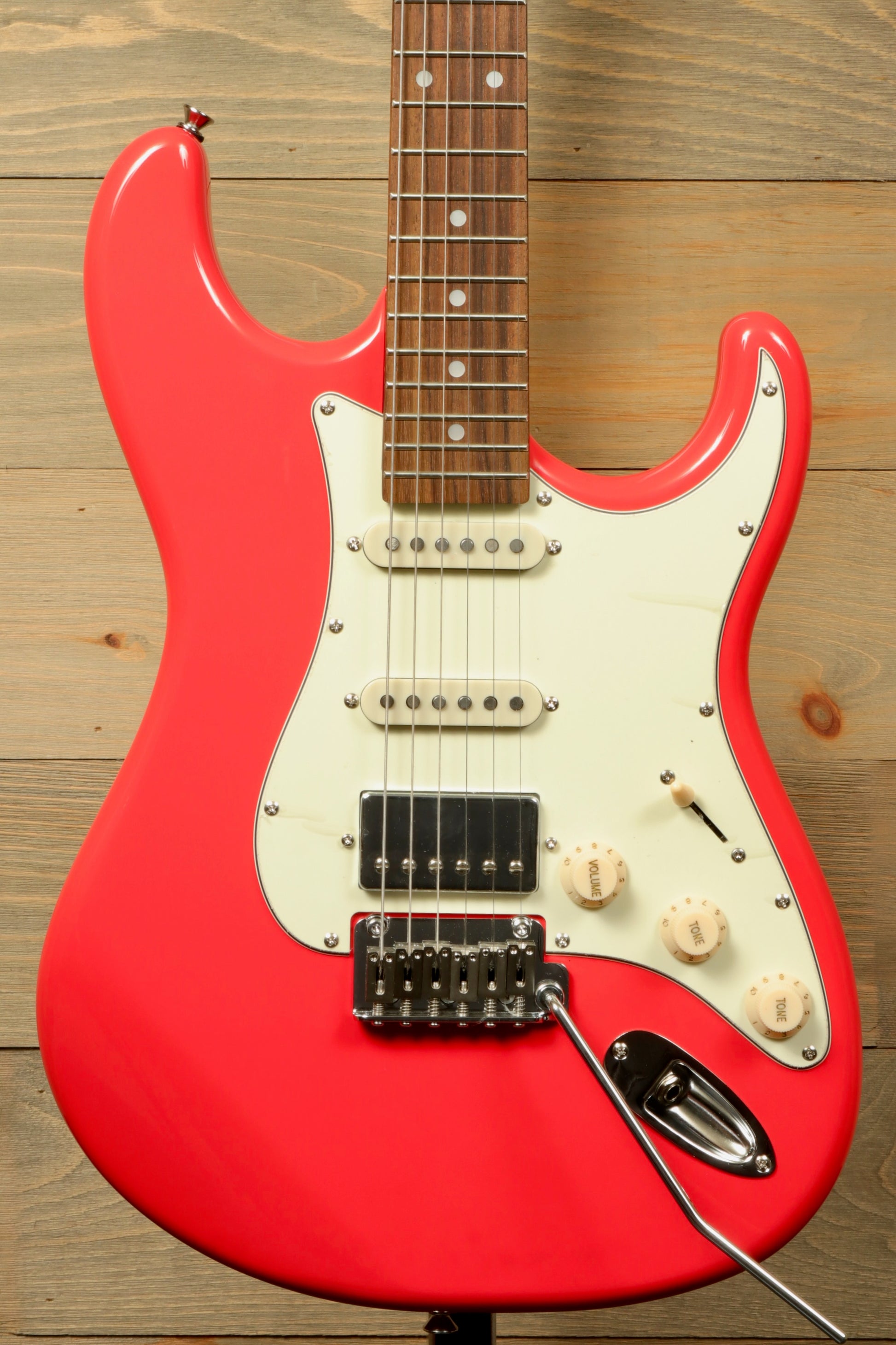 Tagima T 640 SUPER bright red electric guitar, front view showcasing its sleek design and pickups