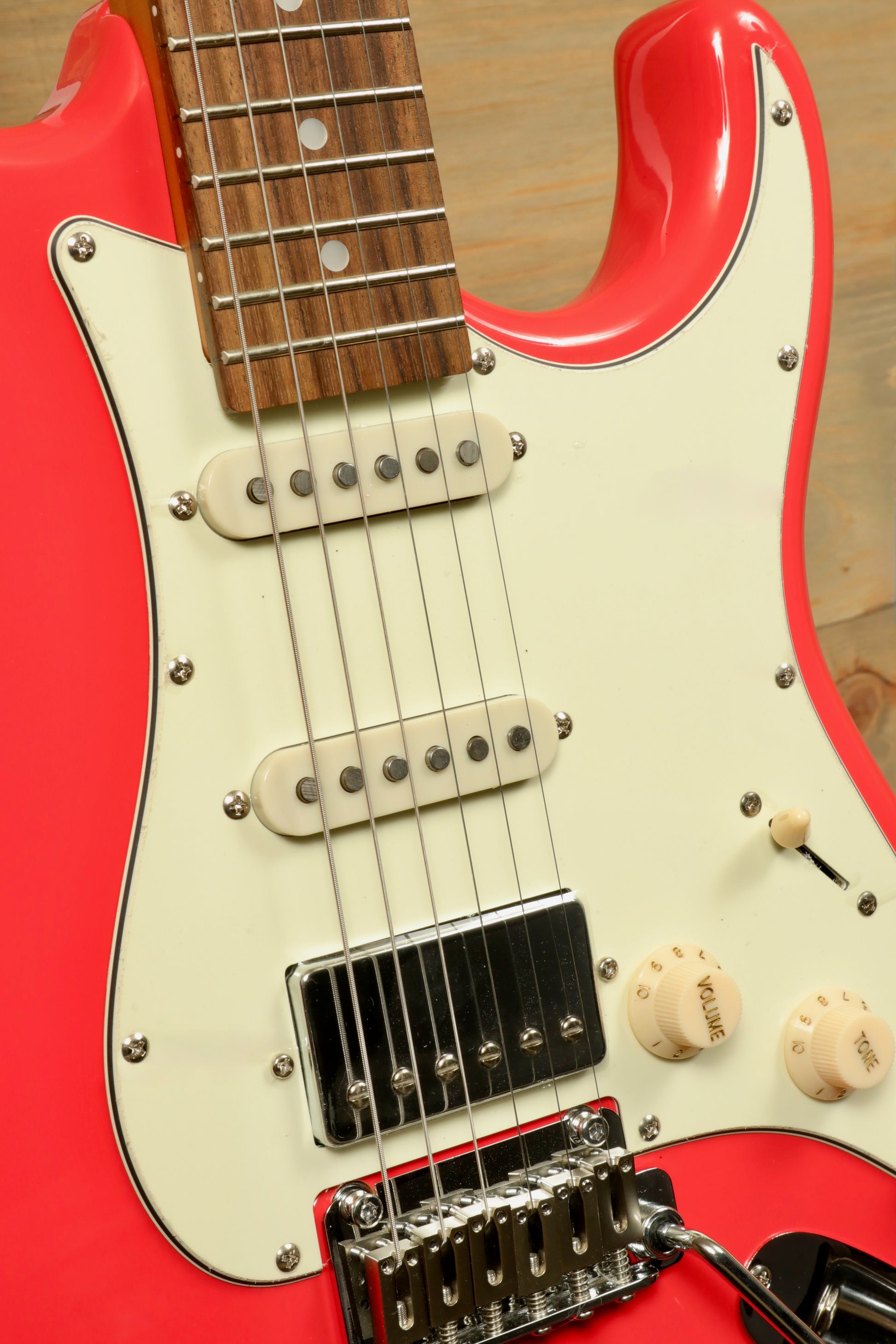 Tagima T 640 SUPER electric guitar in bright red, close-up view with white pickguard and chrome hardware