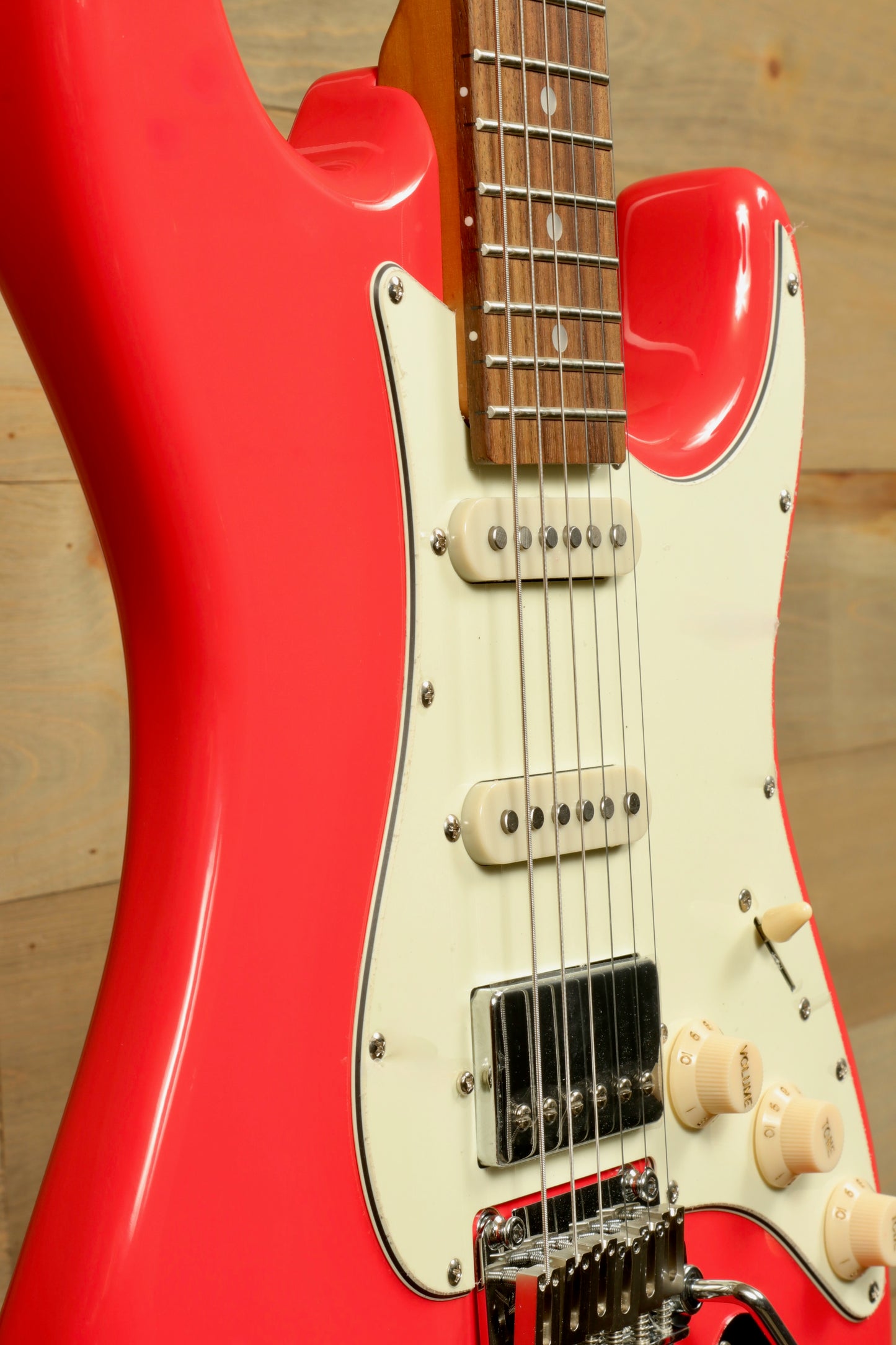 Tagima T 640 SUPER electric guitar in vibrant red finish, side view highlighting the body and neck