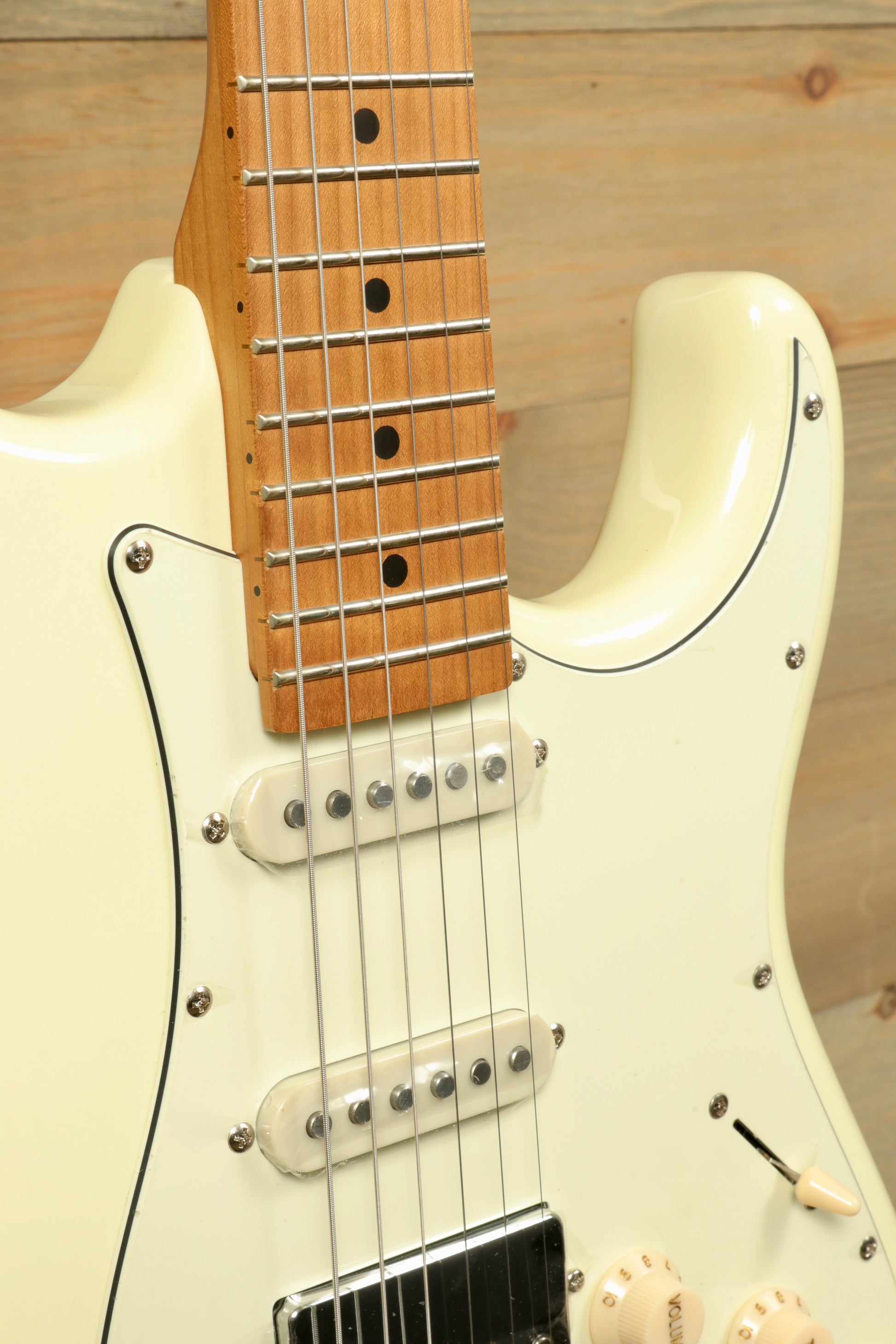 Tagima T 640 SUPER electric guitar in cream finish, front view showcasing the neck and pickups