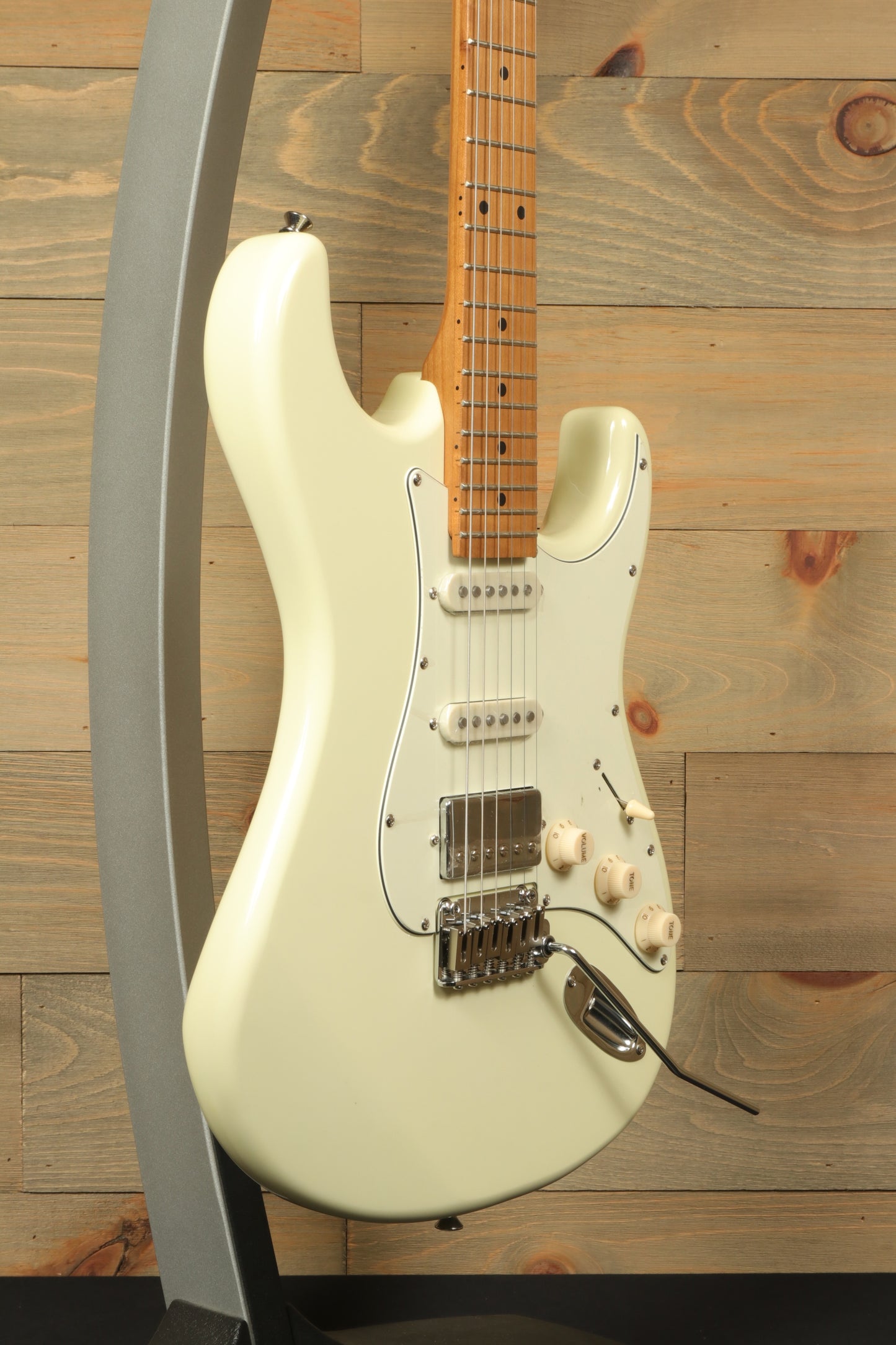 Tagima T 640 SUPER electric guitar in creamy white, side view showcasing sleek design and features