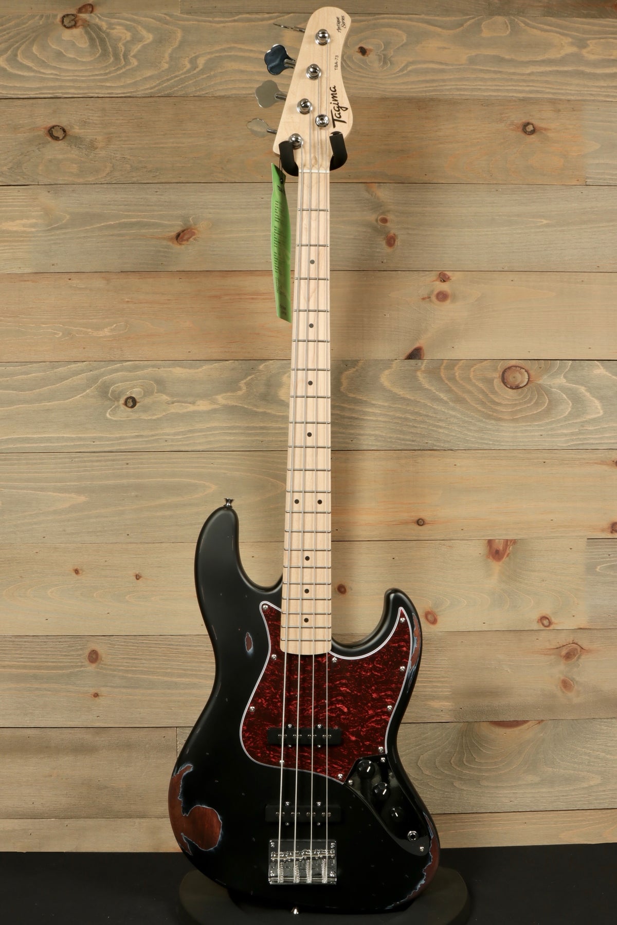 Tagima TBA-73 Electric Bass in black with a pearloid red pickguard, front view