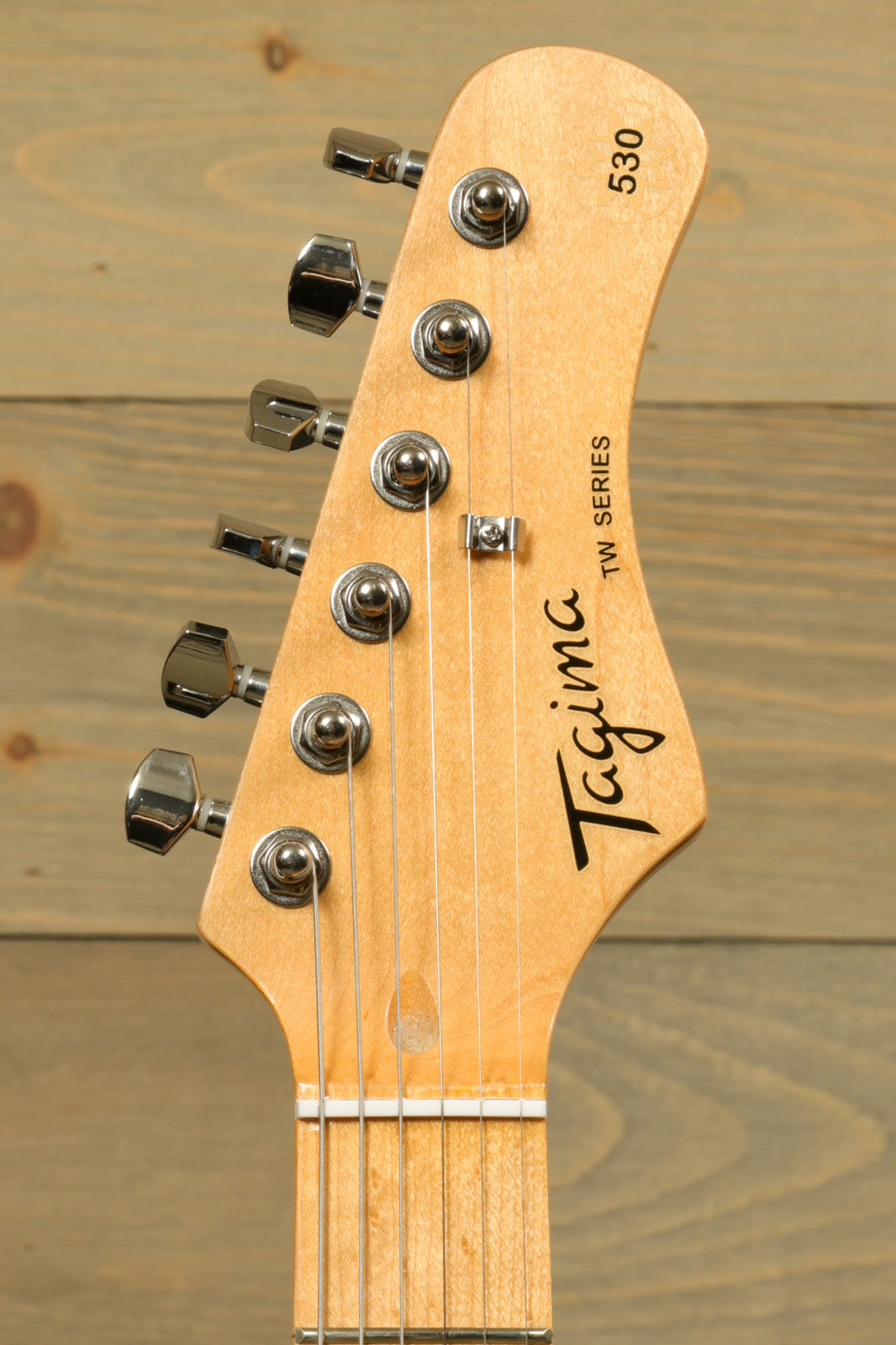 Tagima TG 530 electric guitar headstock with chrome tuning pegs and smooth wooden finish