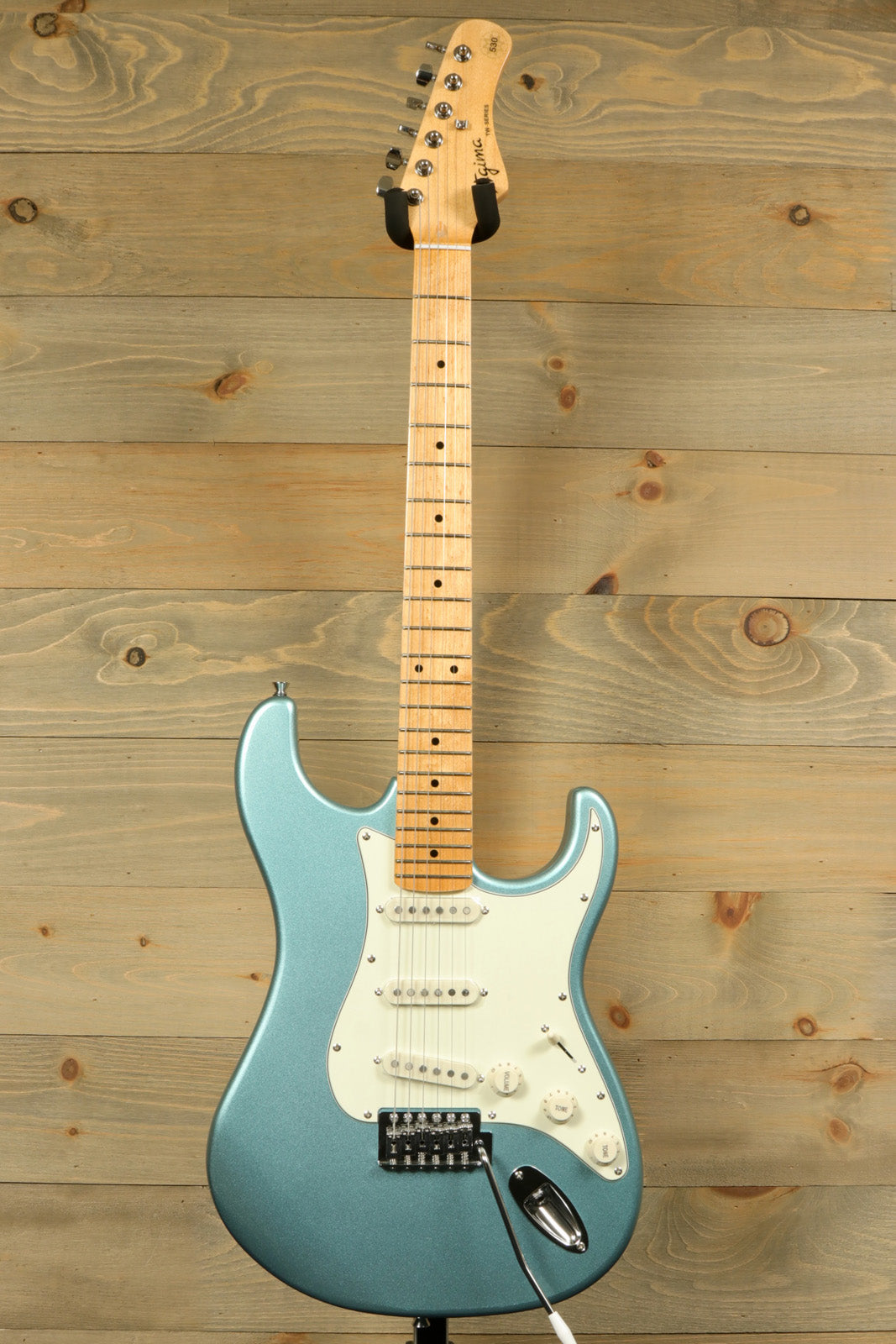 Tagima TG 530 electric guitar in teal blue with a classic design and sleek body