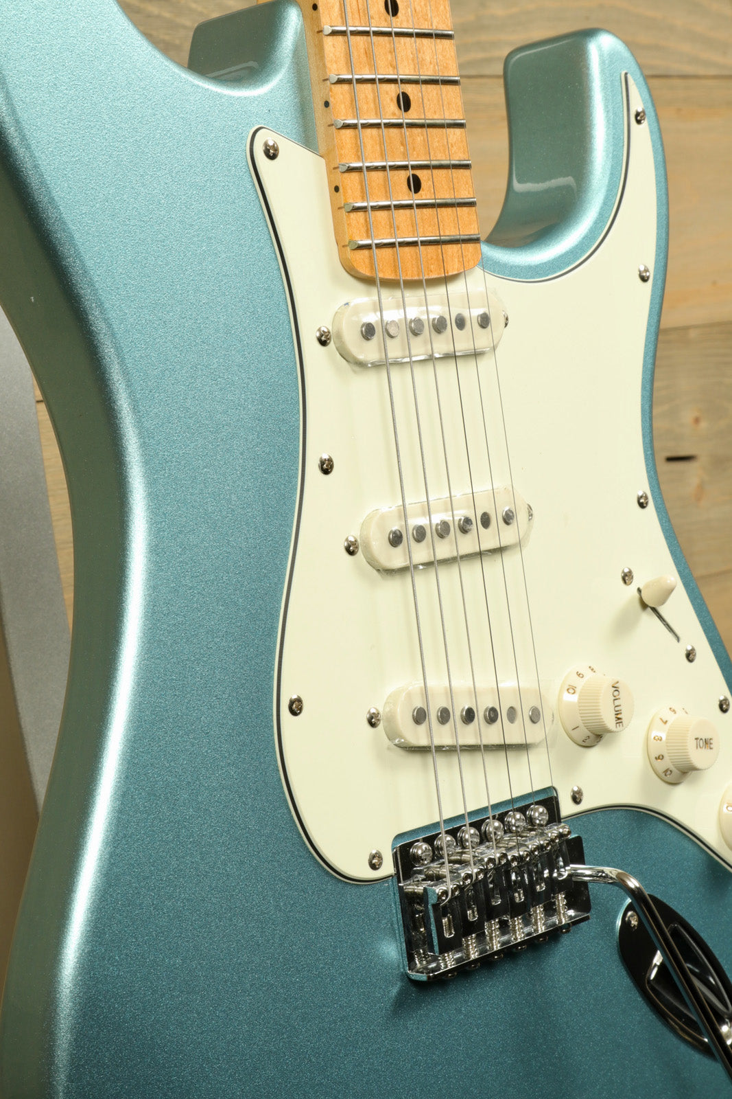 Tagima TG 530 electric guitar in teal with a sleek body and white pickguard