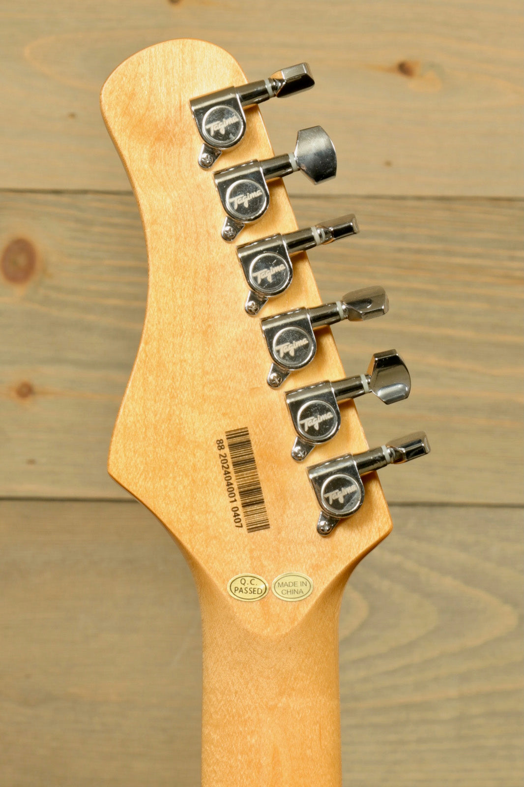 Back view of Tagima TG 540 electric guitar showcasing tuning pegs and smooth finish
