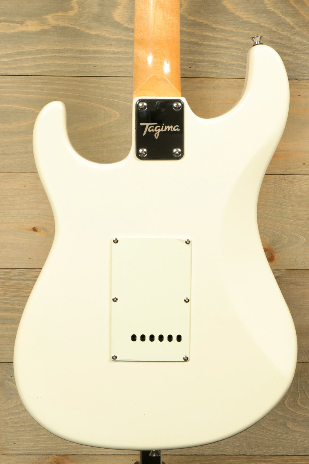 Back view of Tagima TG 540 electric guitar in white featuring sleek contours and elegant design