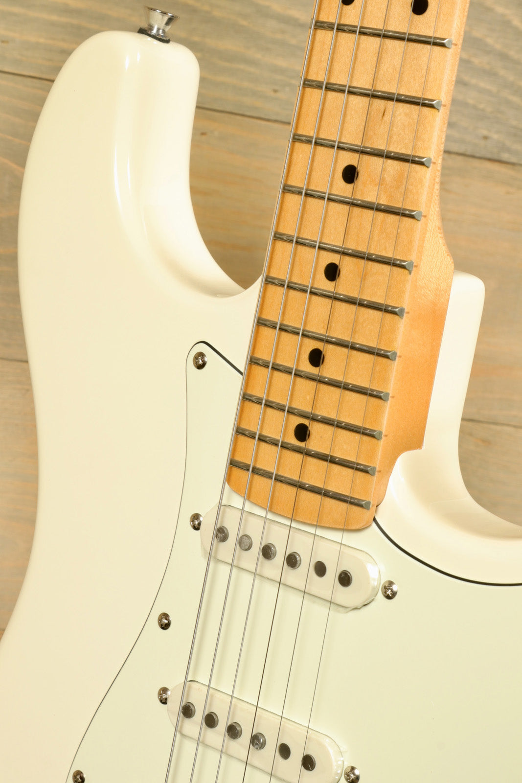 Close-up of Tagima TG 540 electric guitar with cream body and maple neck featuring fretboard details