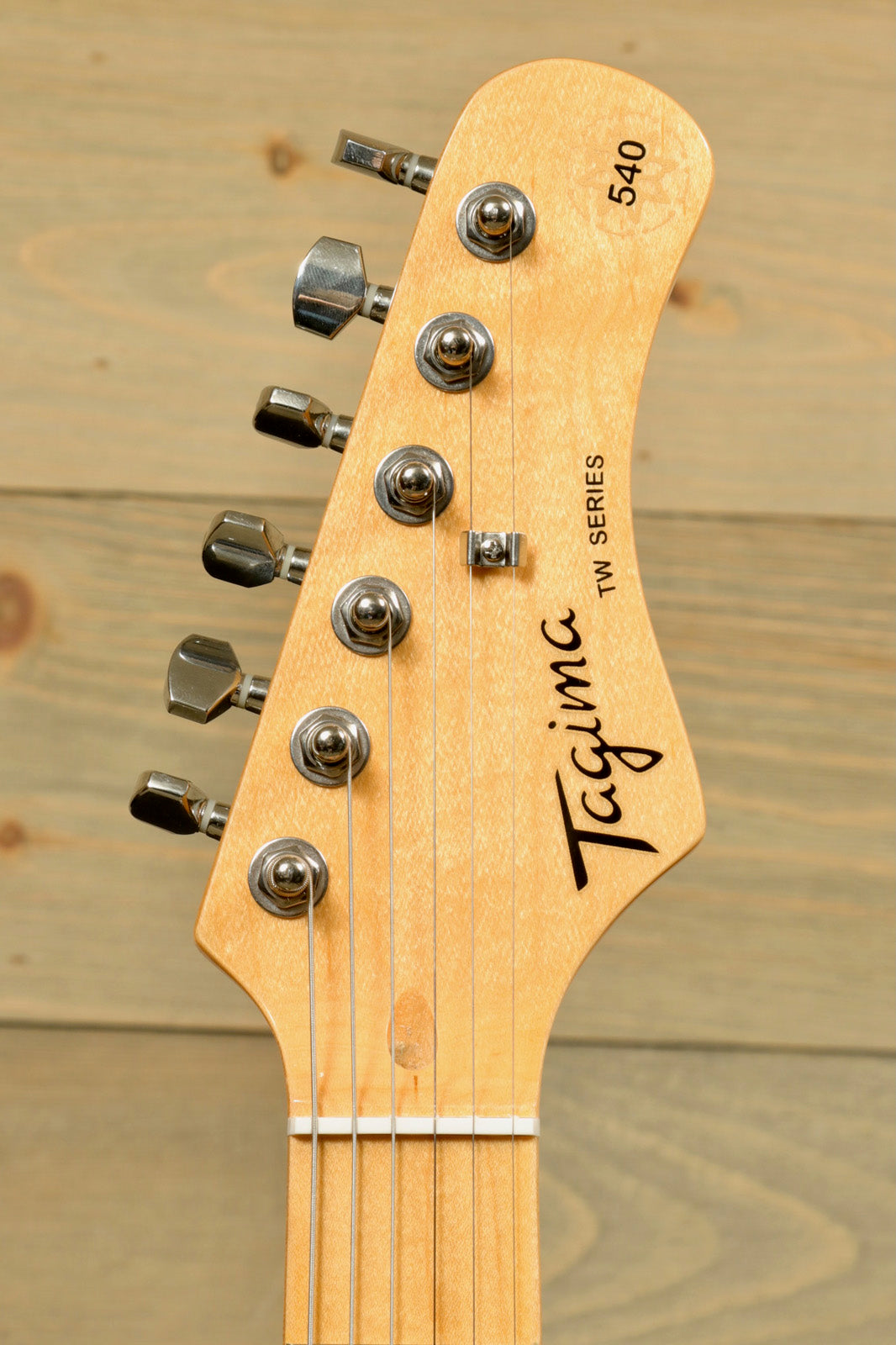 Tagima TG 540 electric guitar headstock with tuning pegs and logo detail