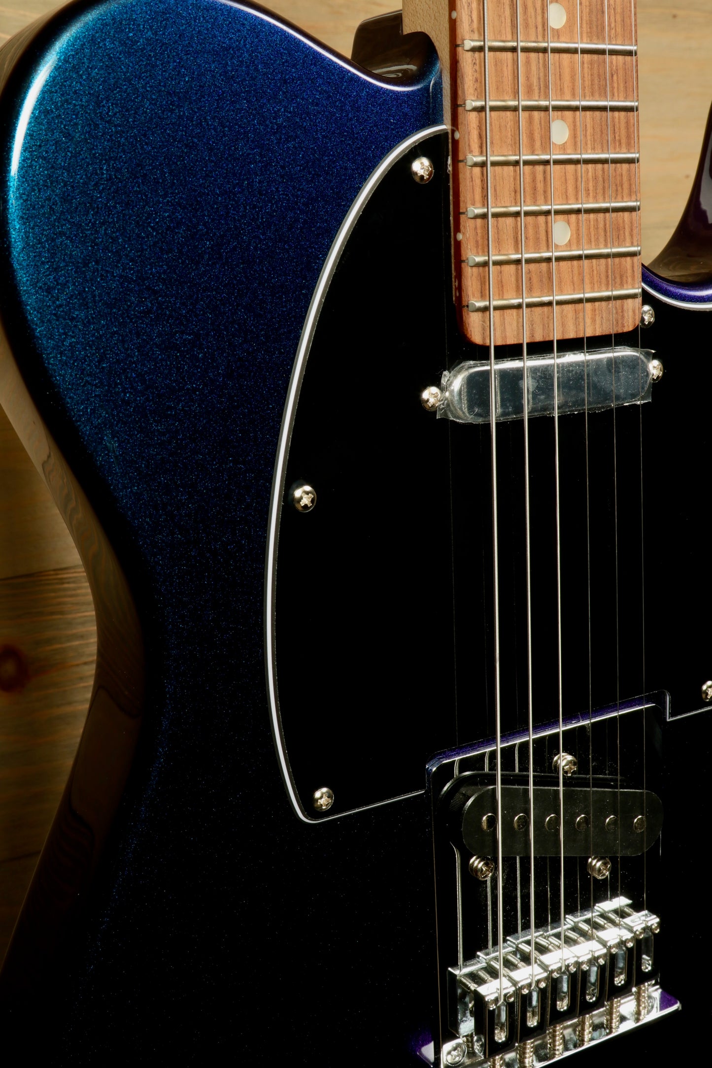 Tagima TW 55 MCBL/BK Electric Guitar in blue sparkle finish, side view showcasing its hardware