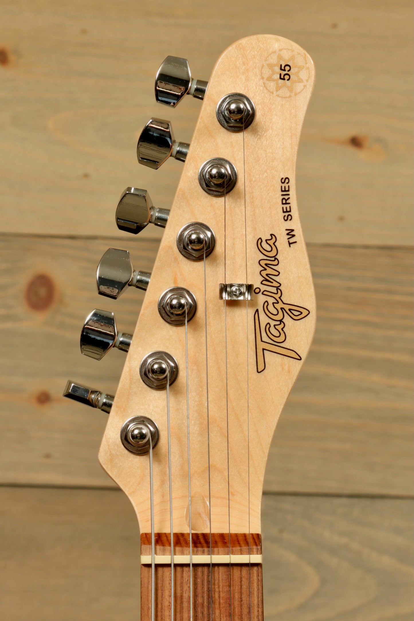 Tagima TW 55 MCBL/BK Electric Guitar headstock, showcasing chrome tuners and wood finish