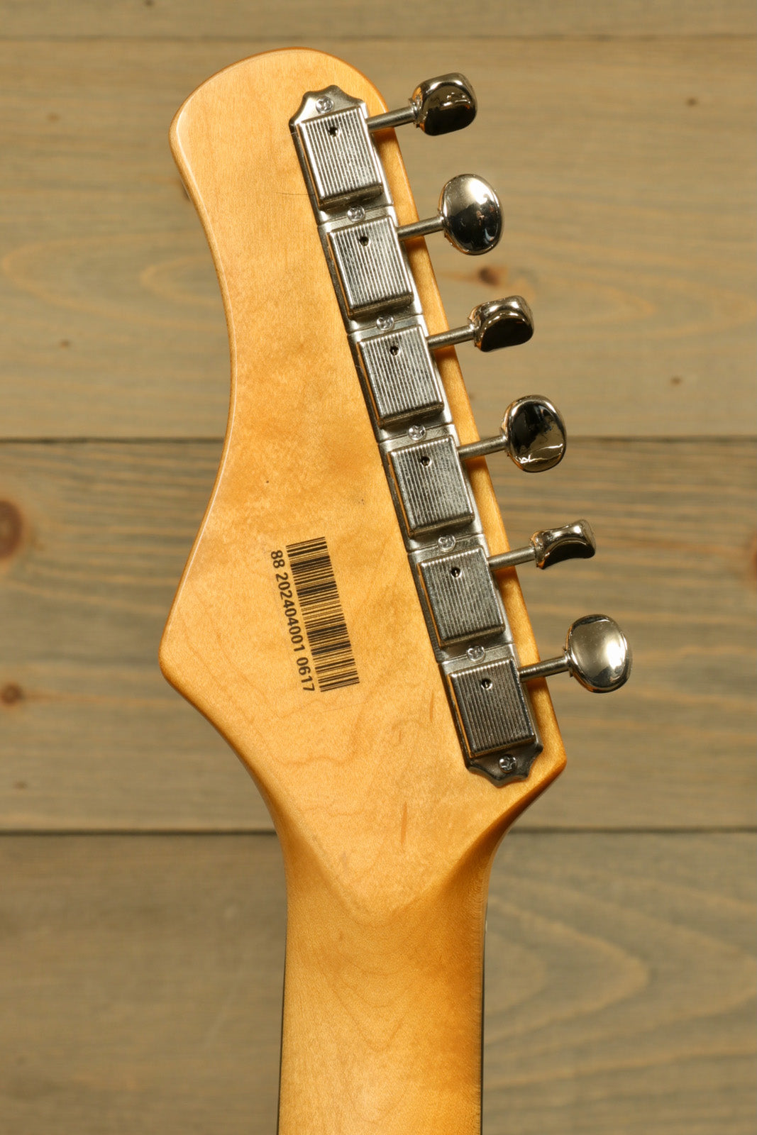 Tagima TW 61 Fiesta Red electric guitar headstock with chrome tuning pegs and wood finish