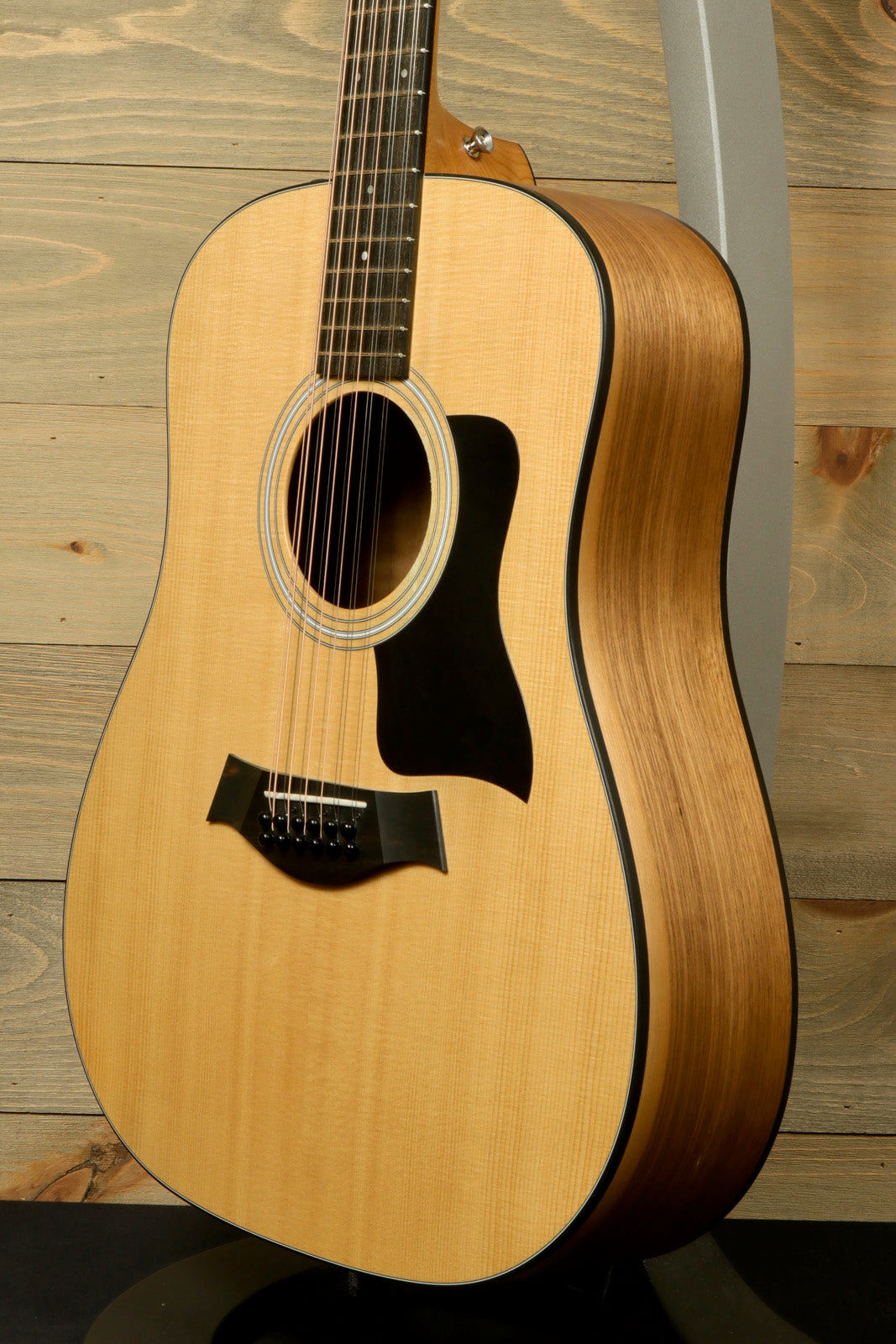 Taylor 150e - USED acoustic electric guitar, natural finish, side view with a smooth curve