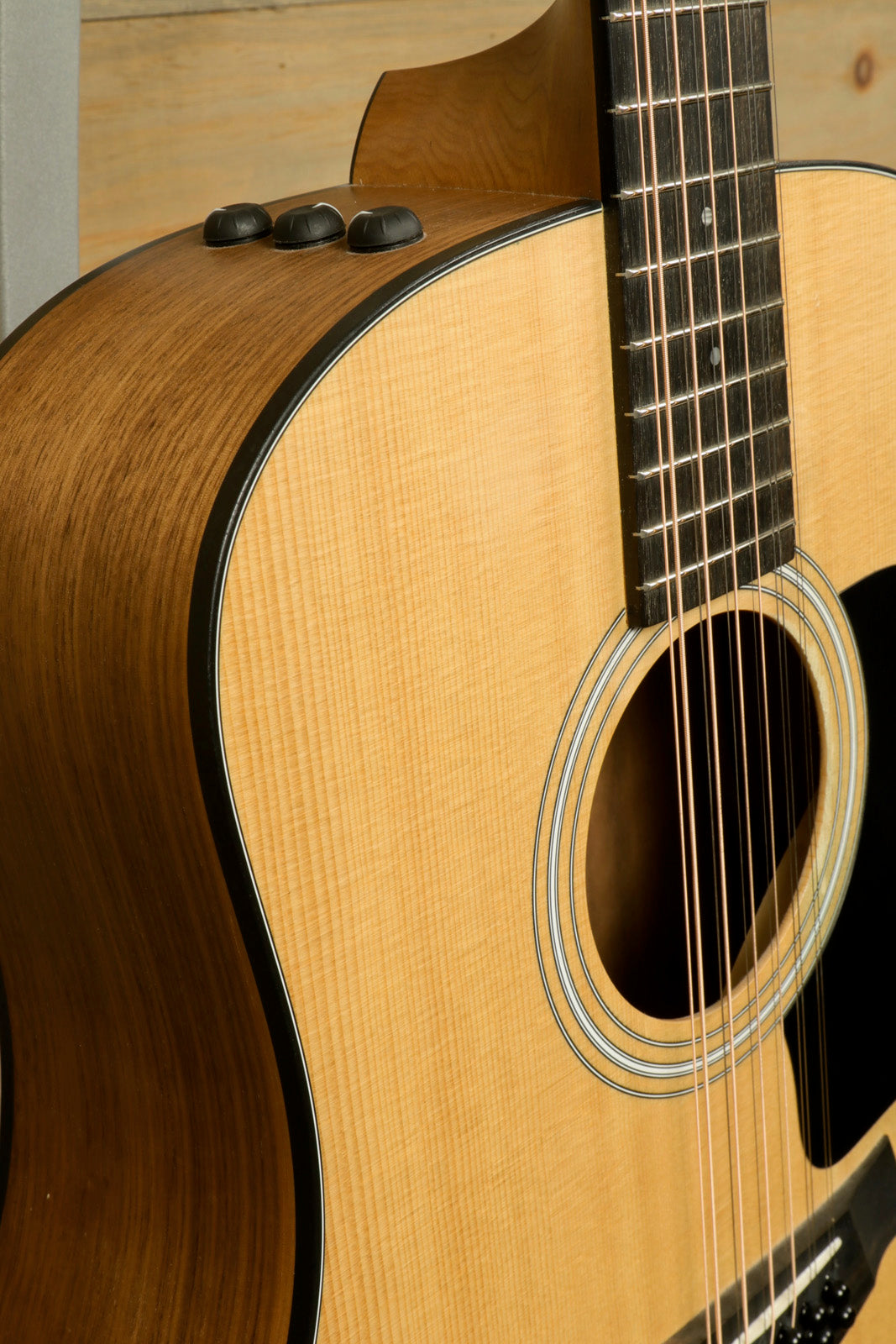 Taylor 150e - USED, acoustic electric guitar with natural finish, side view showing controls
