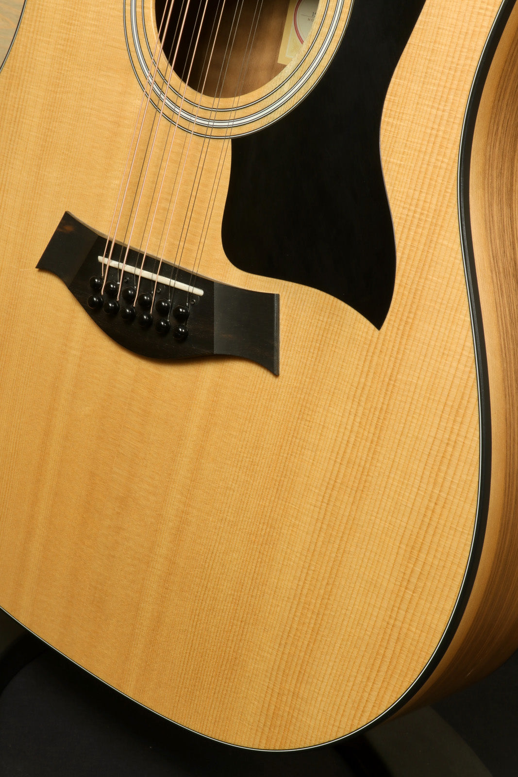 Taylor 150e - USED, natural finish acoustic electric guitar, front view showcasing the body and soundhole.