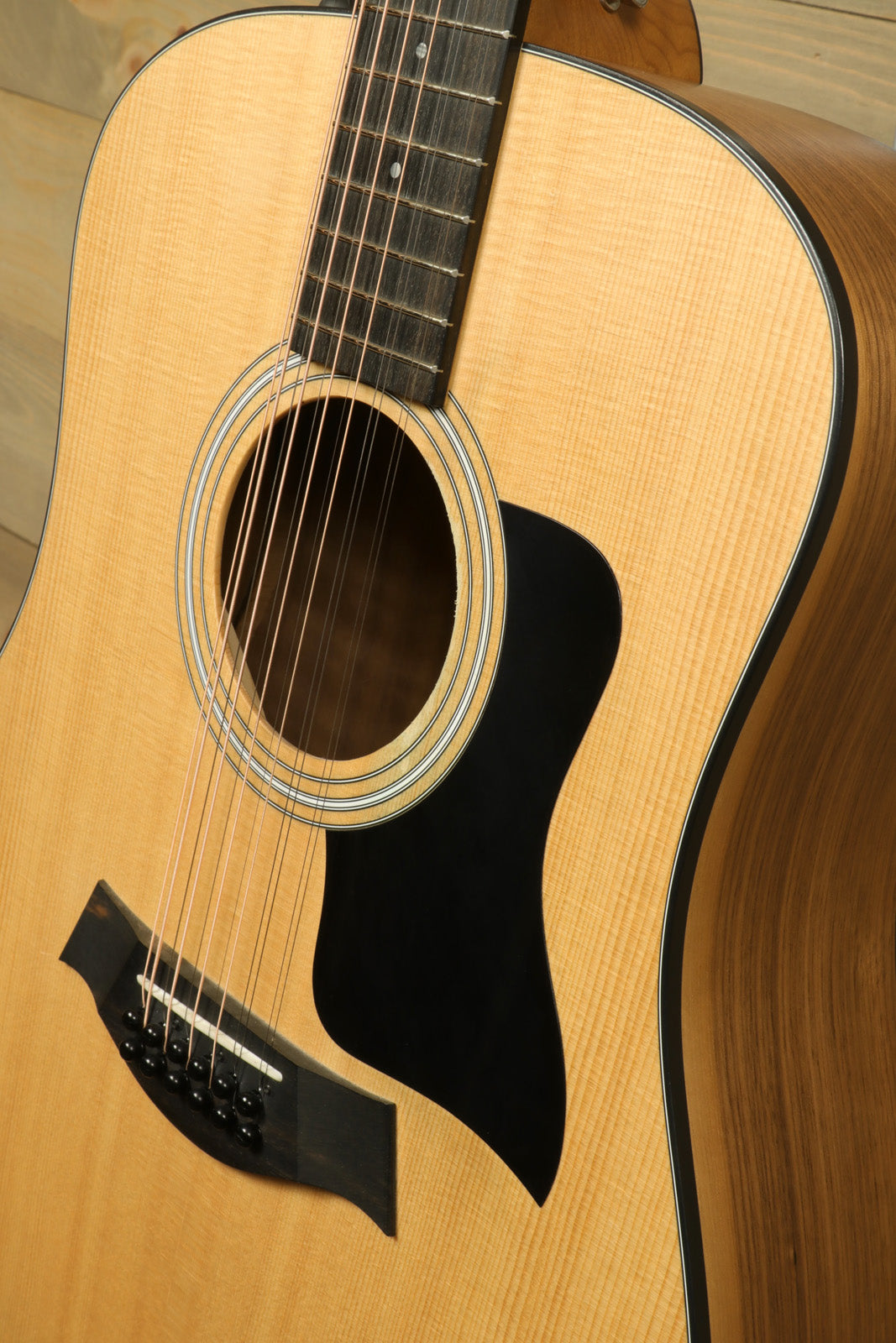 Taylor 150e - USED, natural finish acoustic electric guitar, close-up view of body and soundhole