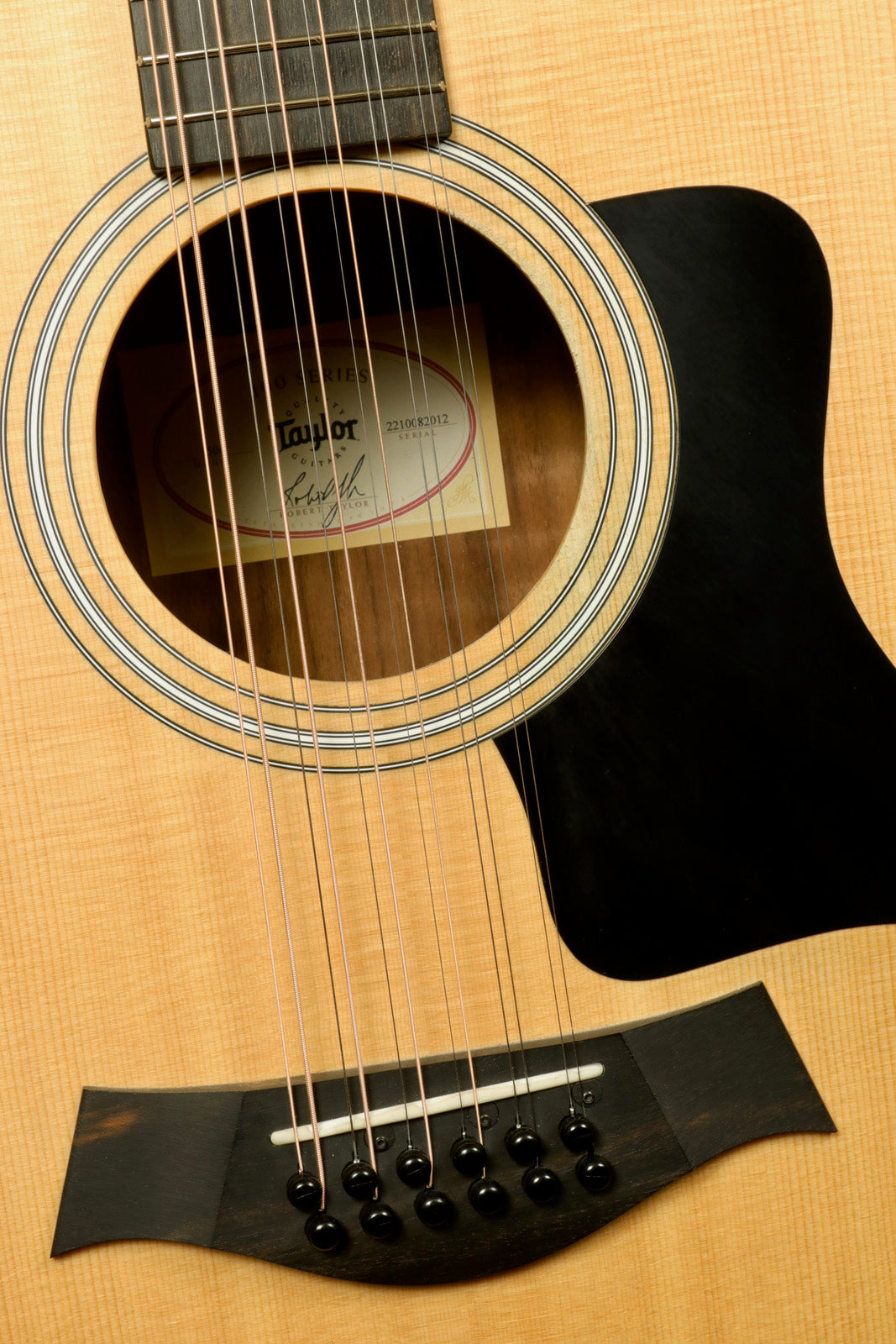 Taylor 150e - USED acoustic electric guitar, natural finish, front view highlighting the soundhole and strings
