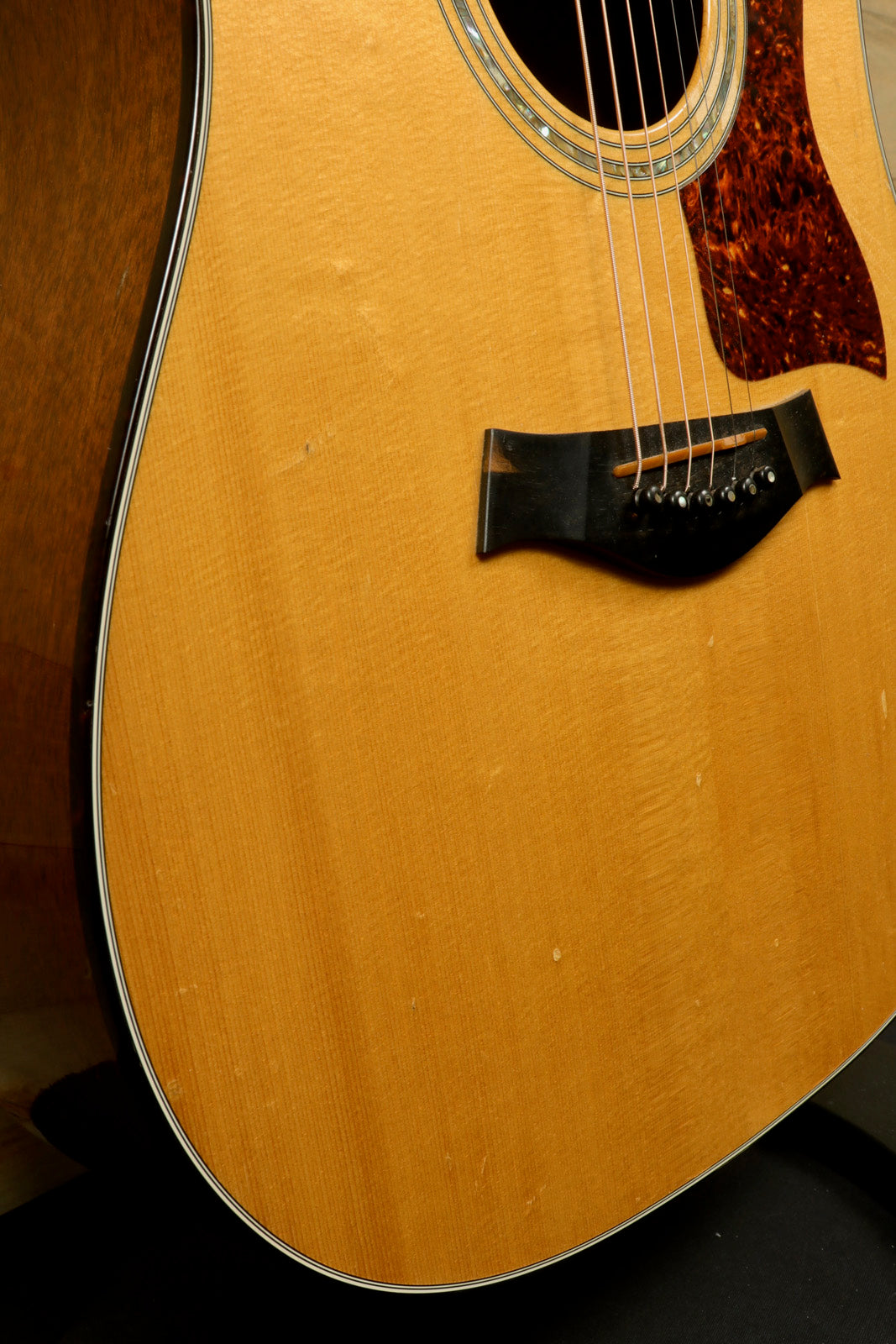 1997 Taylor 510 acoustic guitar with natural finish and original hardshell case, close-up view