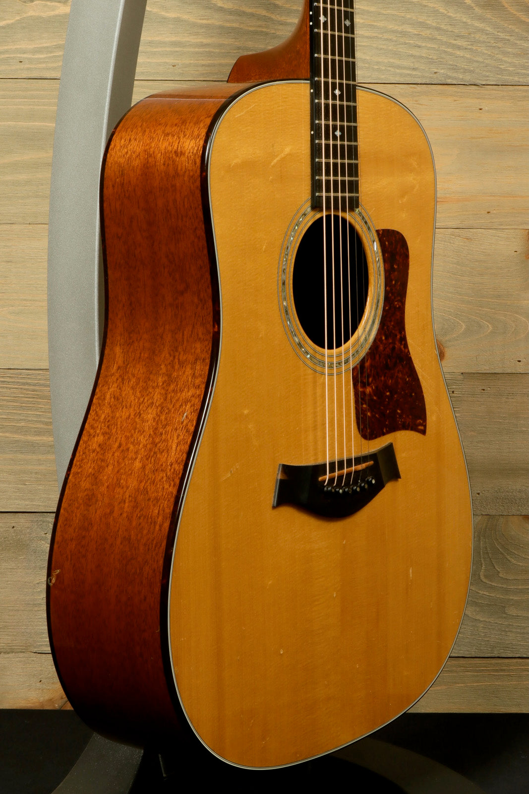 1997 Taylor 510 acoustic guitar with natural finish and original hardshell case, side view