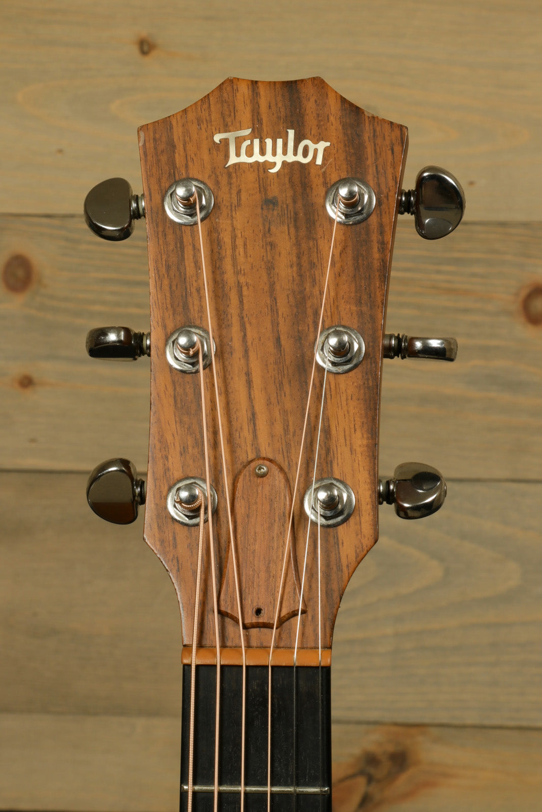 Taylor 1997 510 acoustic guitar with original hardshell case, natural wood finish, front view of headstock