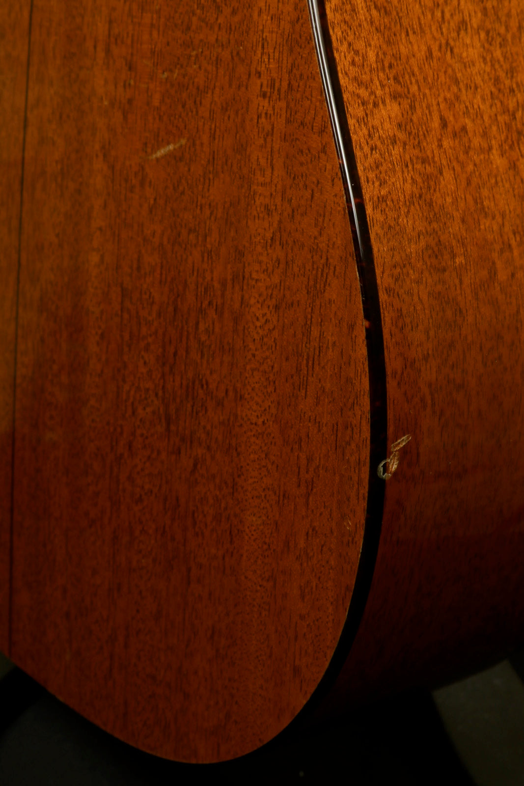 Taylor 1997 510 acoustic guitar with original hardshell case, showcasing rich wood grain finish.