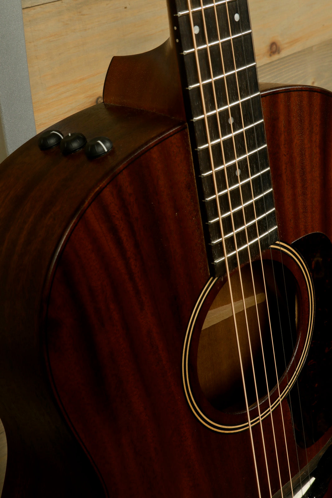 Taylor AD27e with Aerocase, rich brown finish, close-up of body and neck detail