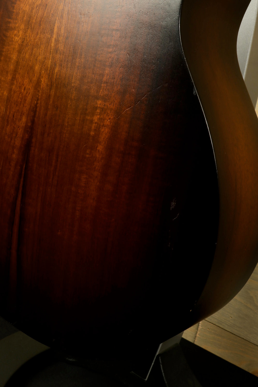 Taylor GS Mini-e Koa acoustic electric guitar body with rich mahogany finish, side view