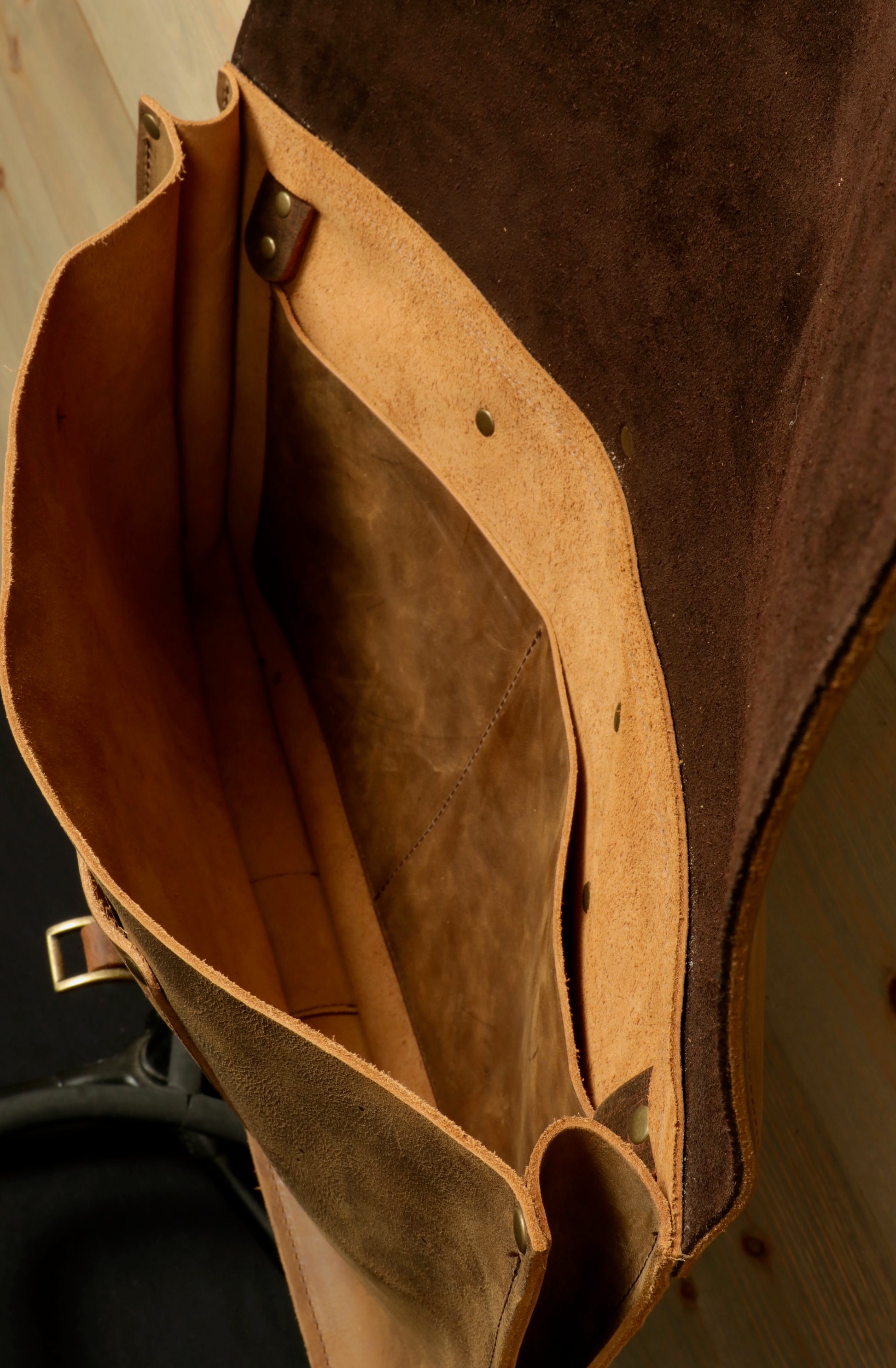 Interior view of Taylor Guitars messenger bag featuring spacious compartments and durable suede material