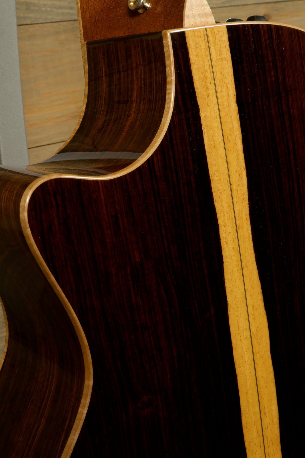 Detailed view of the used Taylor Cocobolo GA LTD guitar showcasing its rich wood grain and fine craftsmanship